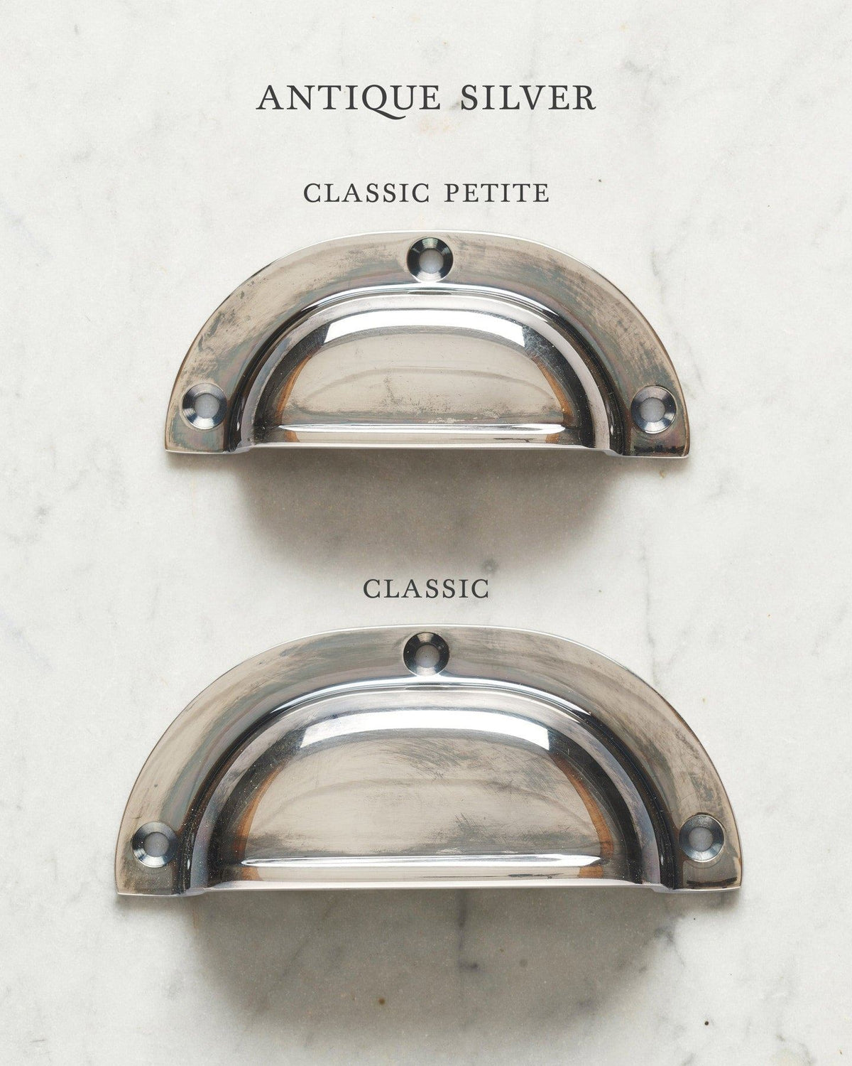 Two classic cup handles for a kitchen cupboard or drawer with a tarnished silver finish. There is a large and a small size. TEST