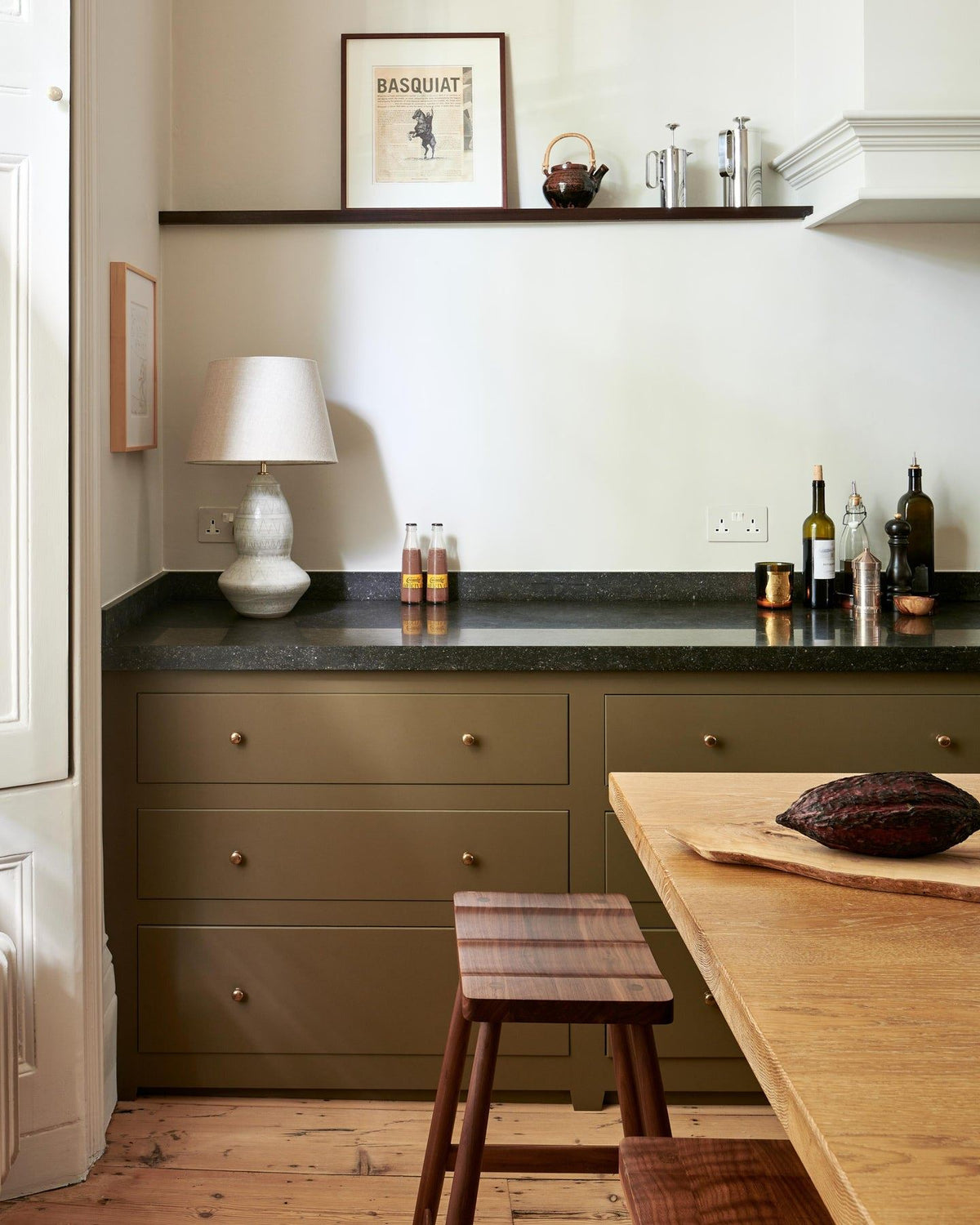 A straight-on view of a mossy green painted Georgian-style kitchen with rows of pan drawers fitted with classic knobs in a bright polished bronze finish.|Medium shown TEST