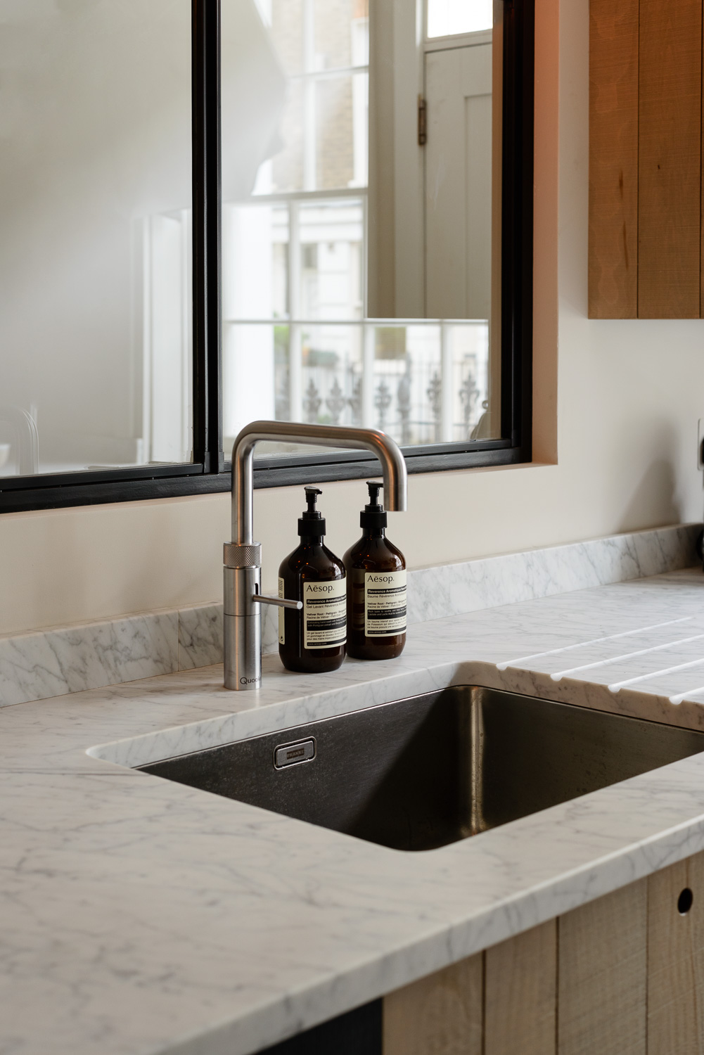 Much less shiny and reflective, this Carrara marble has a honed finish.
