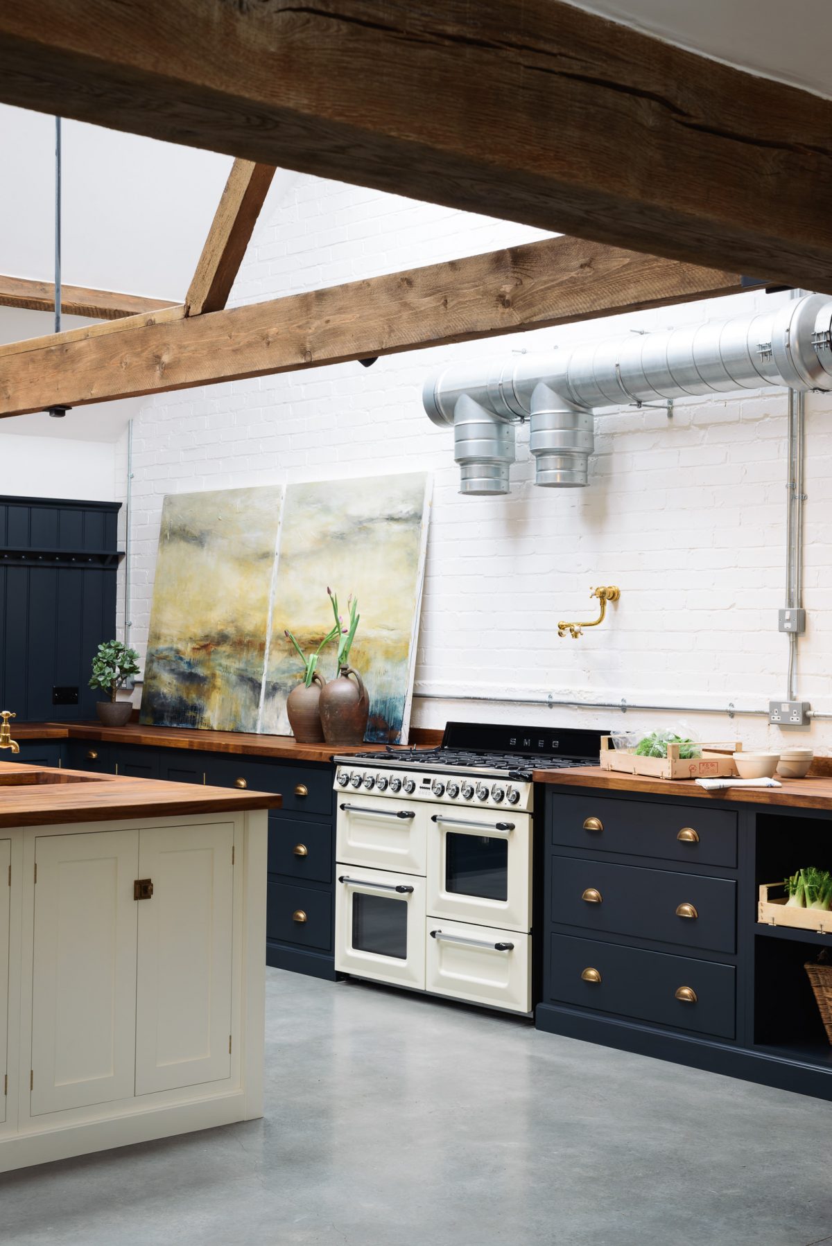 The walls have simply been painted white here, nothing to distract from the beautiful cabinetry and styling.