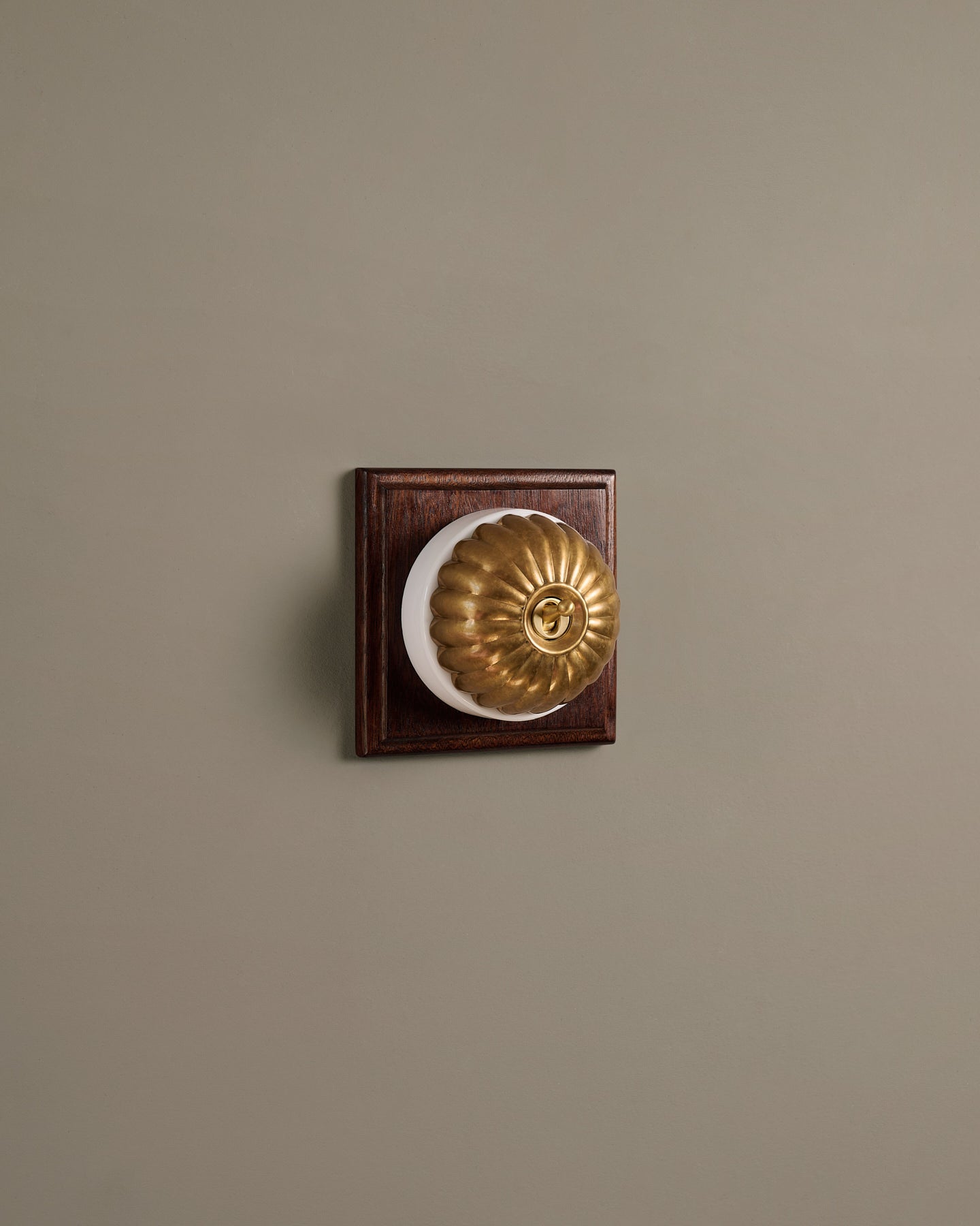 The Jelly Toggle Switch (1 Gang & Mahogany Finish Pattress) - Aged Brass with White Base.