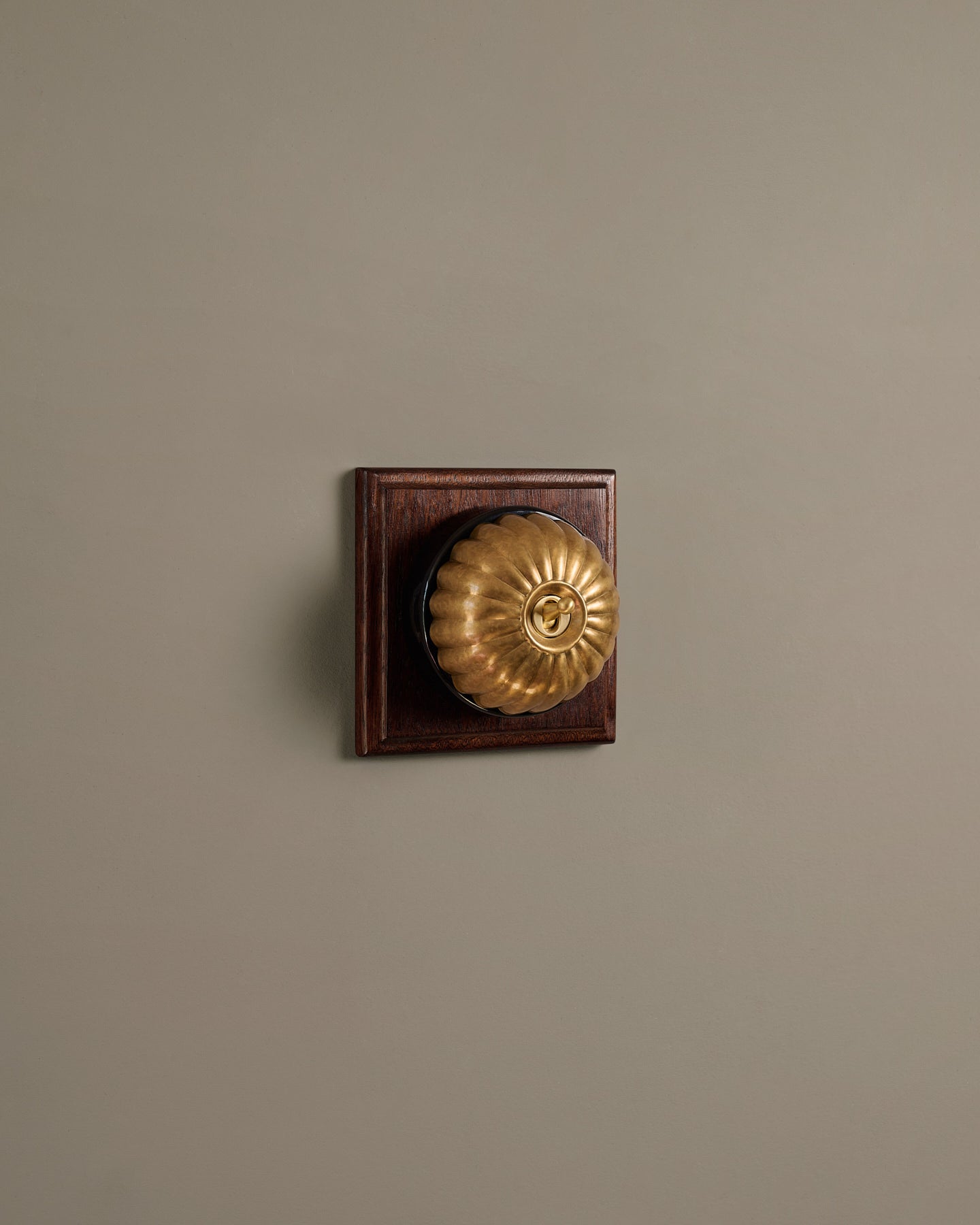The Jelly Toggle Switch (1 Gang & Mahogany Finish Pattress) - Aged Brass with Black Base.