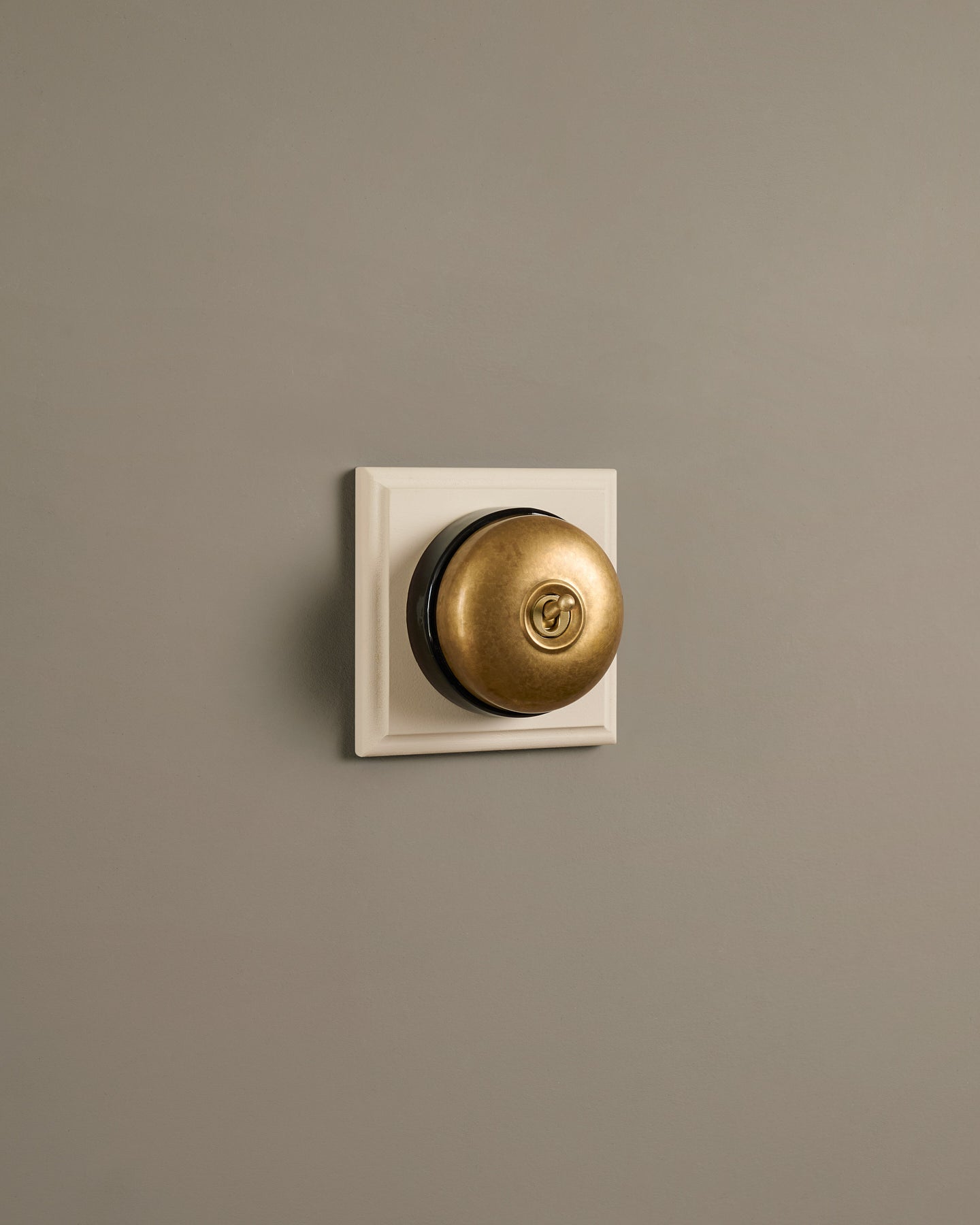 The Dolly Toggle Switch (1 Gang & Primed Maple Pattress) - Aged Brass with Black Base.