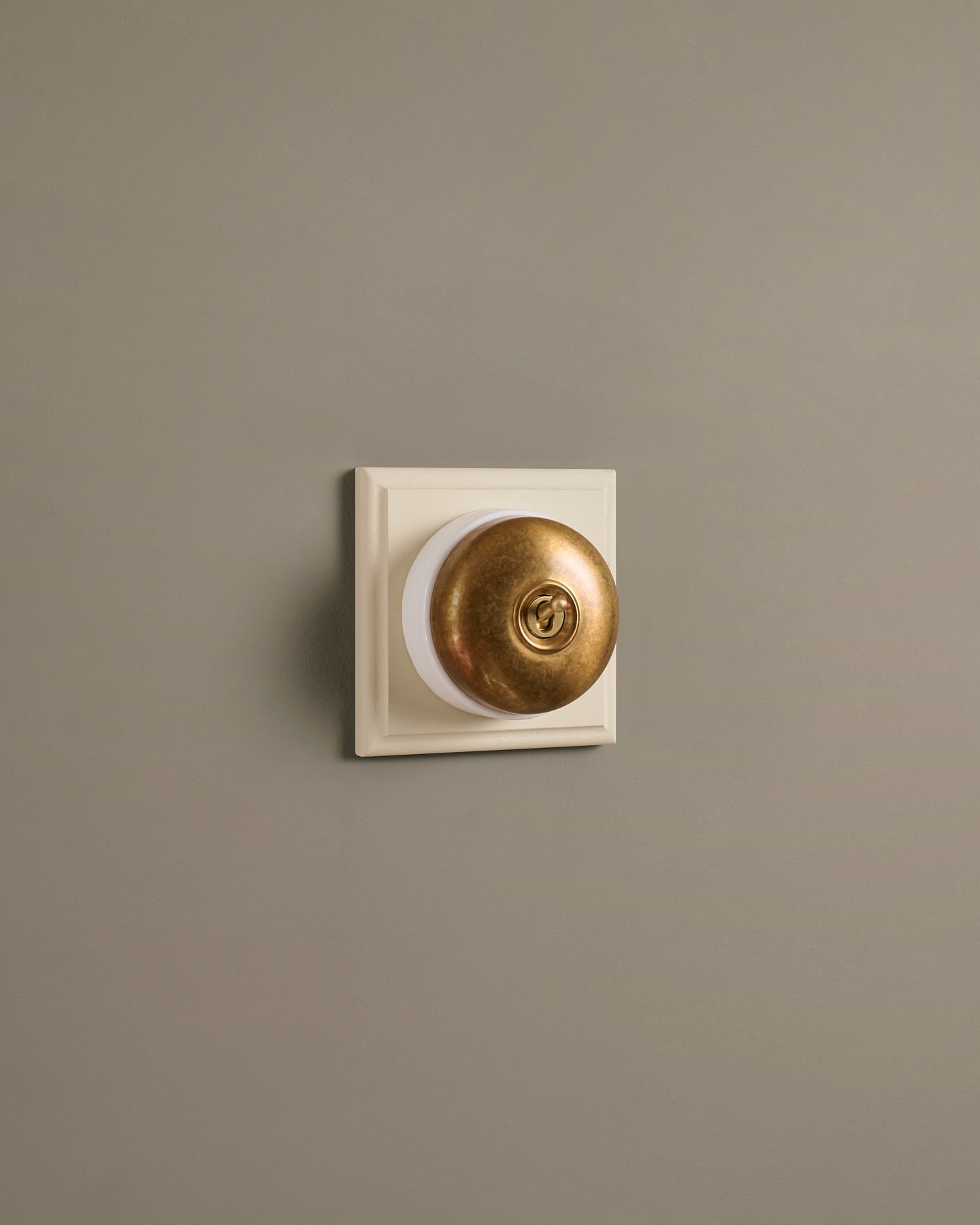 The Dolly Toggle Switch (1 Gang & Primed Maple Pattress) - Aged Brass with White Base.