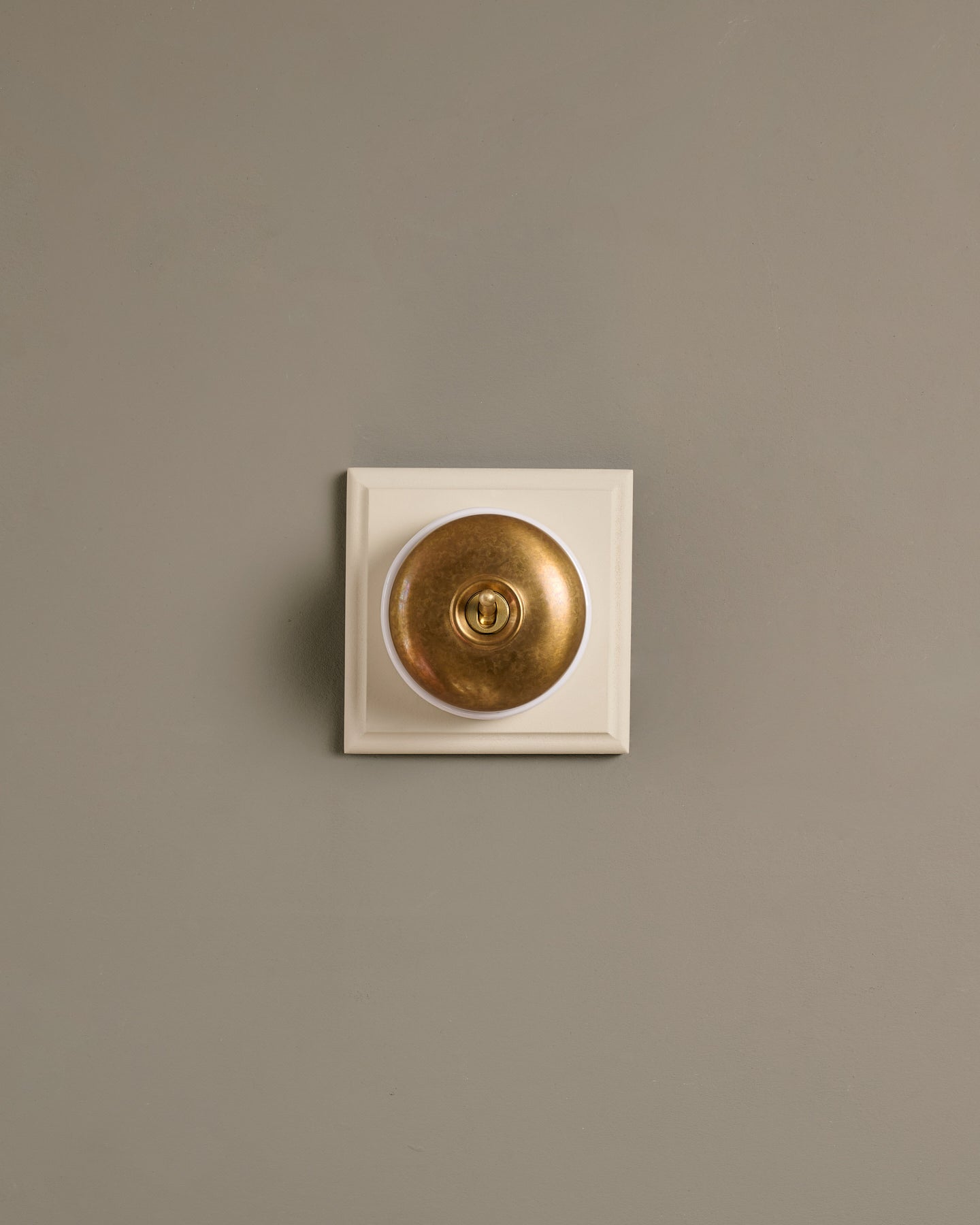 The Dolly Toggle Switch (1 Gang & Primed Maple Pattress) - Aged Brass with White Base.