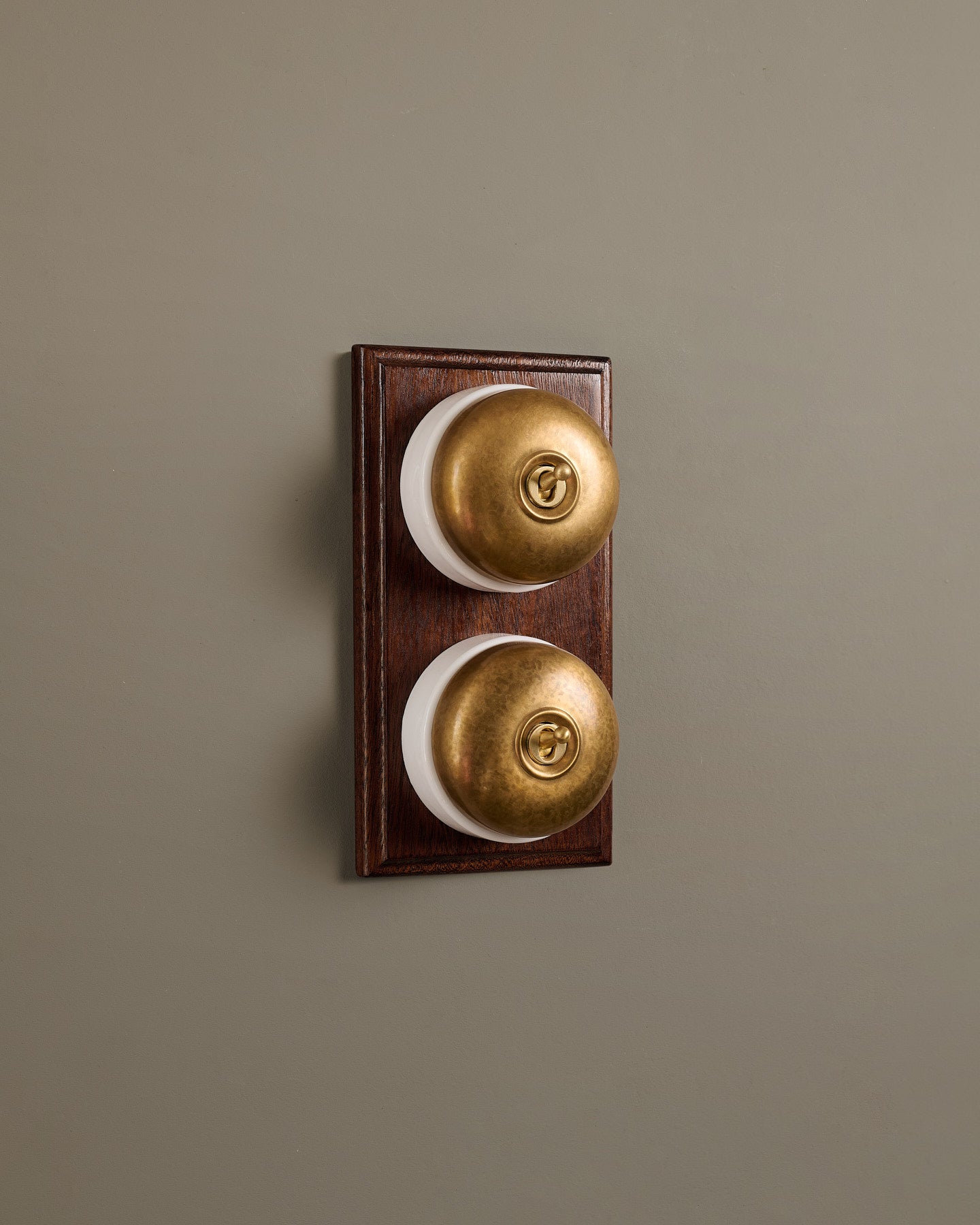 The Dolly Toggle Switch (2 Gang & Mahogany Finish Pattress) - Aged Brass with White Base.