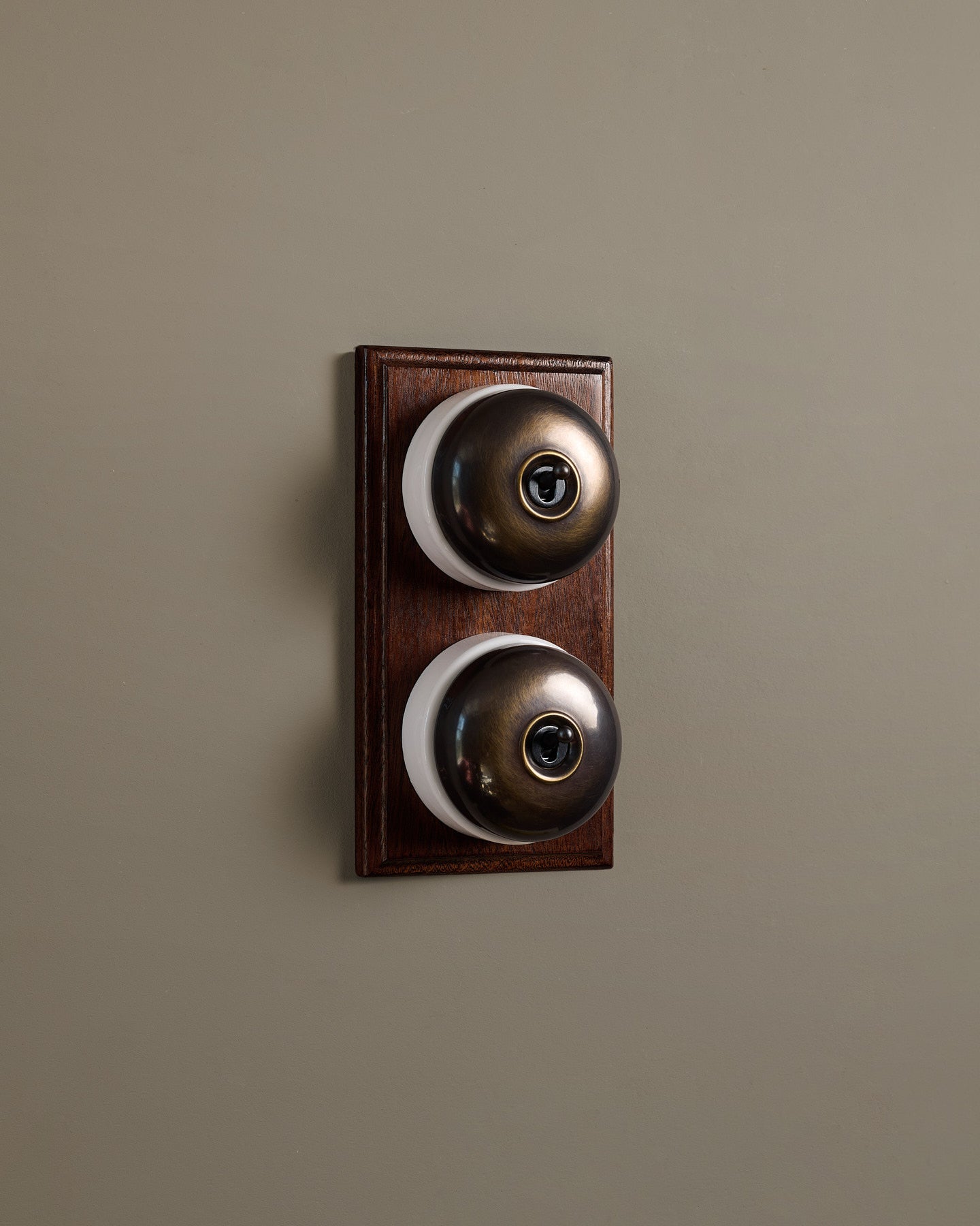The Dolly Toggle Switch (2 Gang & Mahogany Finish Pattress) - Oxidised Brass with White Base.