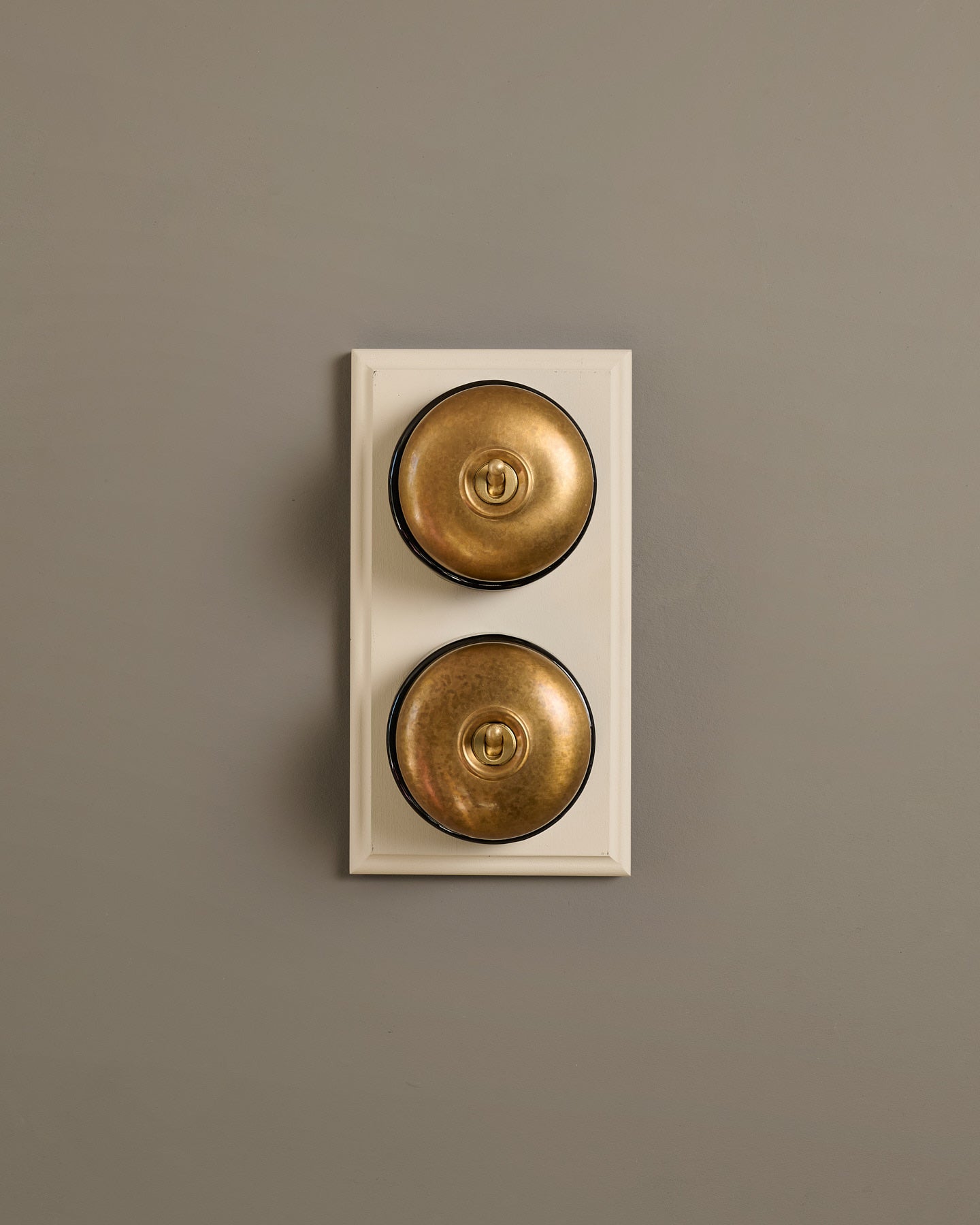 The Dolly Toggle Switch (2 Gang & Primed Maple Pattress) - Aged Brass with Black Base.