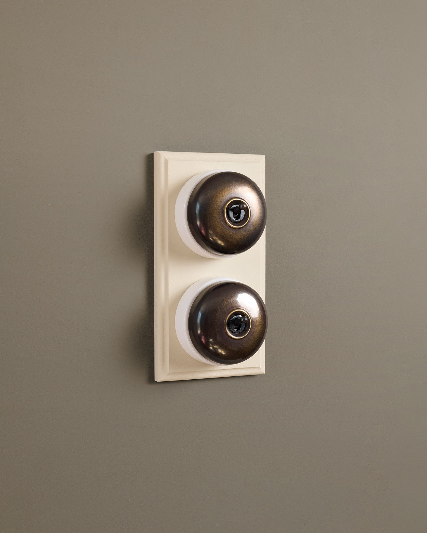 The Dolly Toggle Switch (2 Gang & Primed Maple Pattress) - Oxidised Brass with White Base.