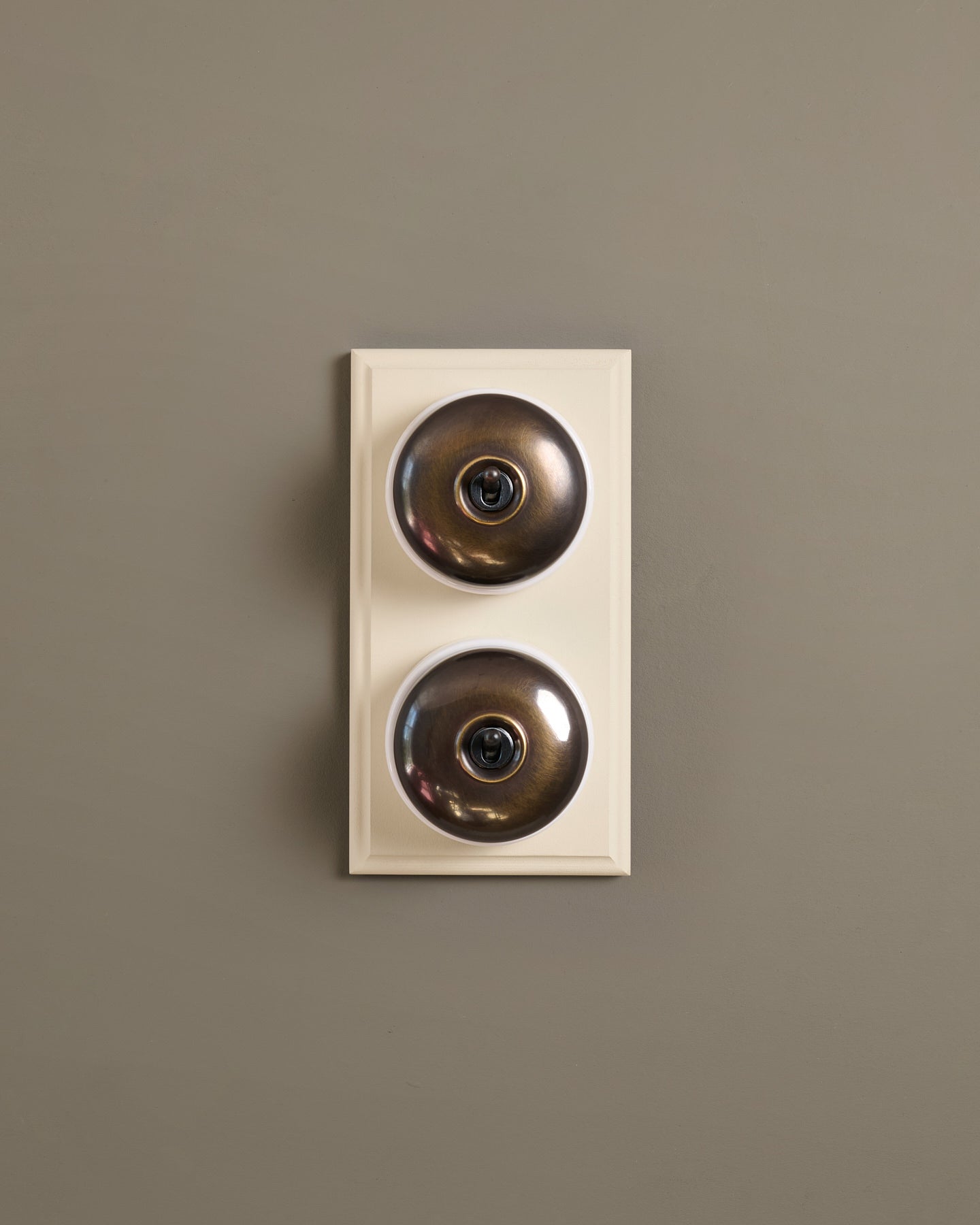 The Dolly Toggle Switch (2 Gang & Primed Maple Pattress) - Oxidised Brass with White Base.