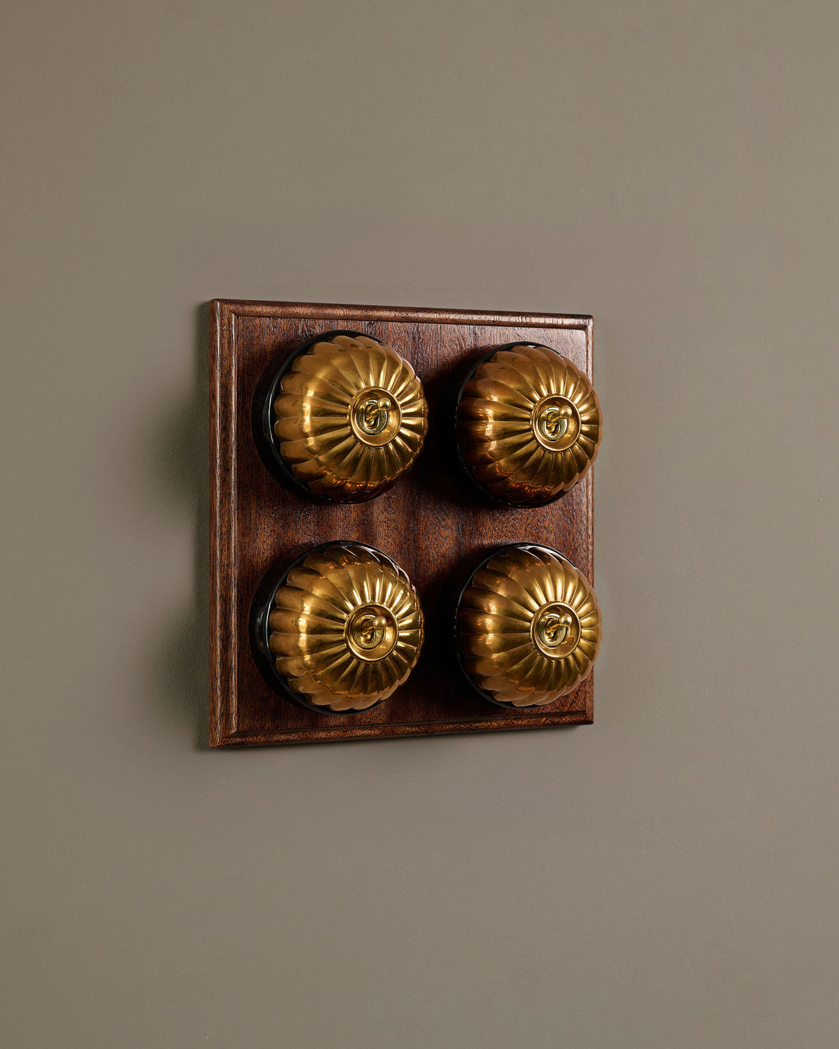 The Jelly Toggle Switch (4 Gang Bank & Mahogany Finish Pattress) - Heirloom Brass with Black Base. TEST