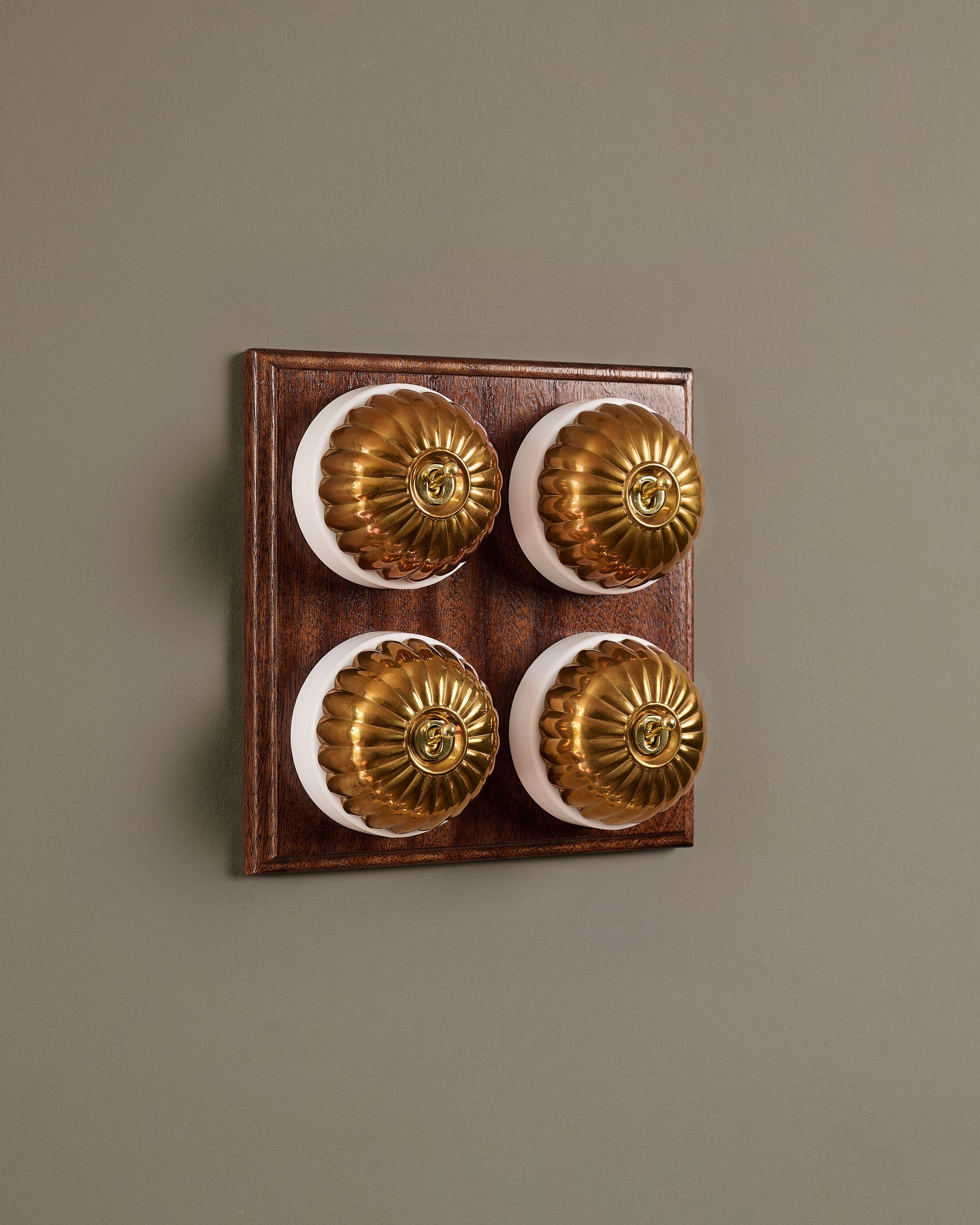 The Jelly Toggle Switch (4 Gang Bank & Mahogany Finish Pattress) - Heirloom Brass with White Base.