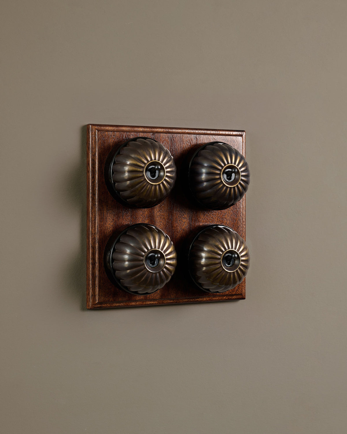 The Jelly Toggle Switch (4 Gang Bank & Mahogany Finish Pattress) - Oxidised Brass with Black Base. TEST