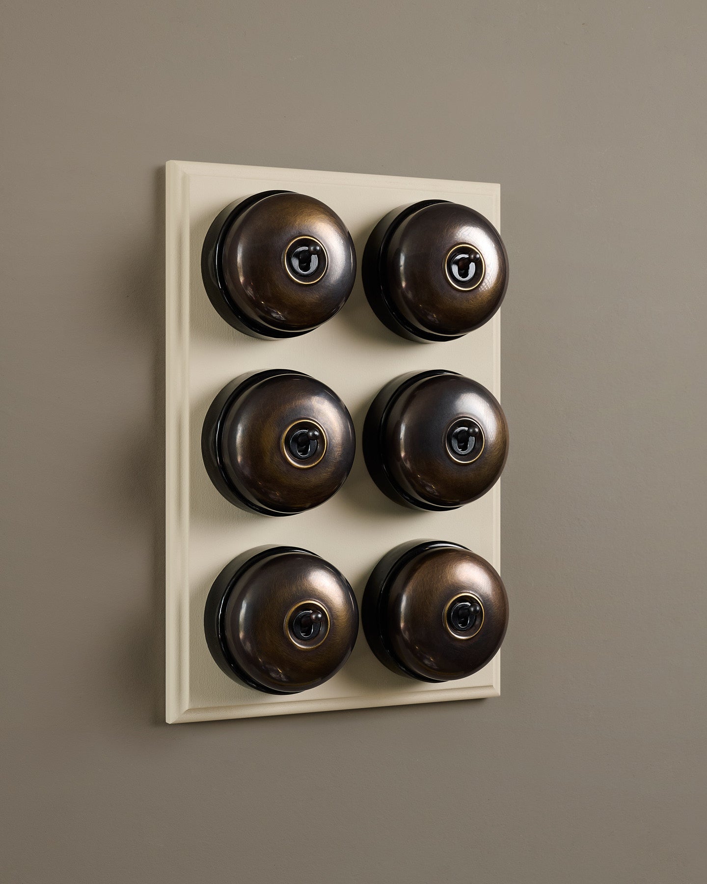 The Dolly Toggle Switch (6 Gang & Primed Maple Pattress) - Oxidised Brass with Black Base.