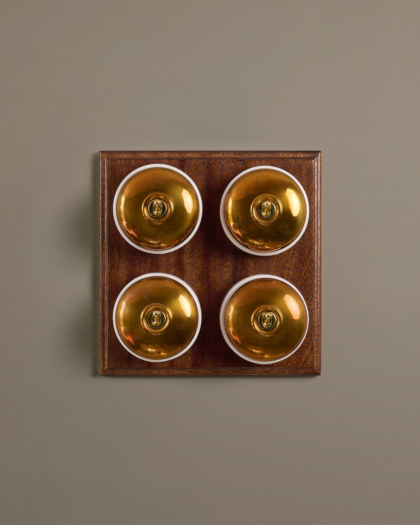 The Dolly Toggle Switch (4 Gang Bank & Mahogany Finish Pattress) - Heirloom Brass with White Base.
