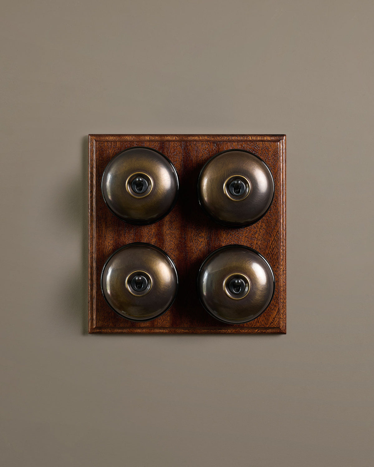 The Dolly Toggle Switch (4 Gang Bank & Mahogany Finish Pattress) - Oxidised Brass with Black Base. TEST