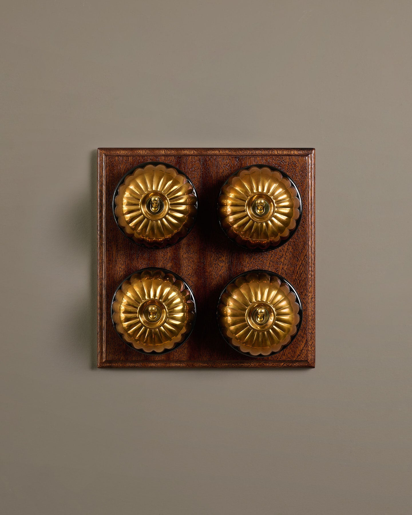 The Jelly Toggle Switch (4 Gang Bank & Mahogany Finish Pattress) - Heirloom Brass with Black Base.