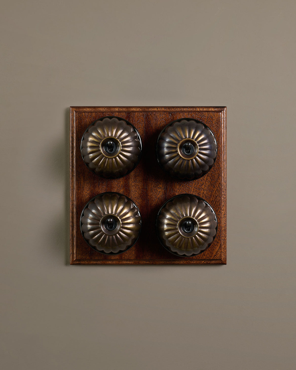The Jelly Toggle Switch (4 Gang Bank & Mahogany Finish Pattress) - Oxidised Brass with Black Base. TEST