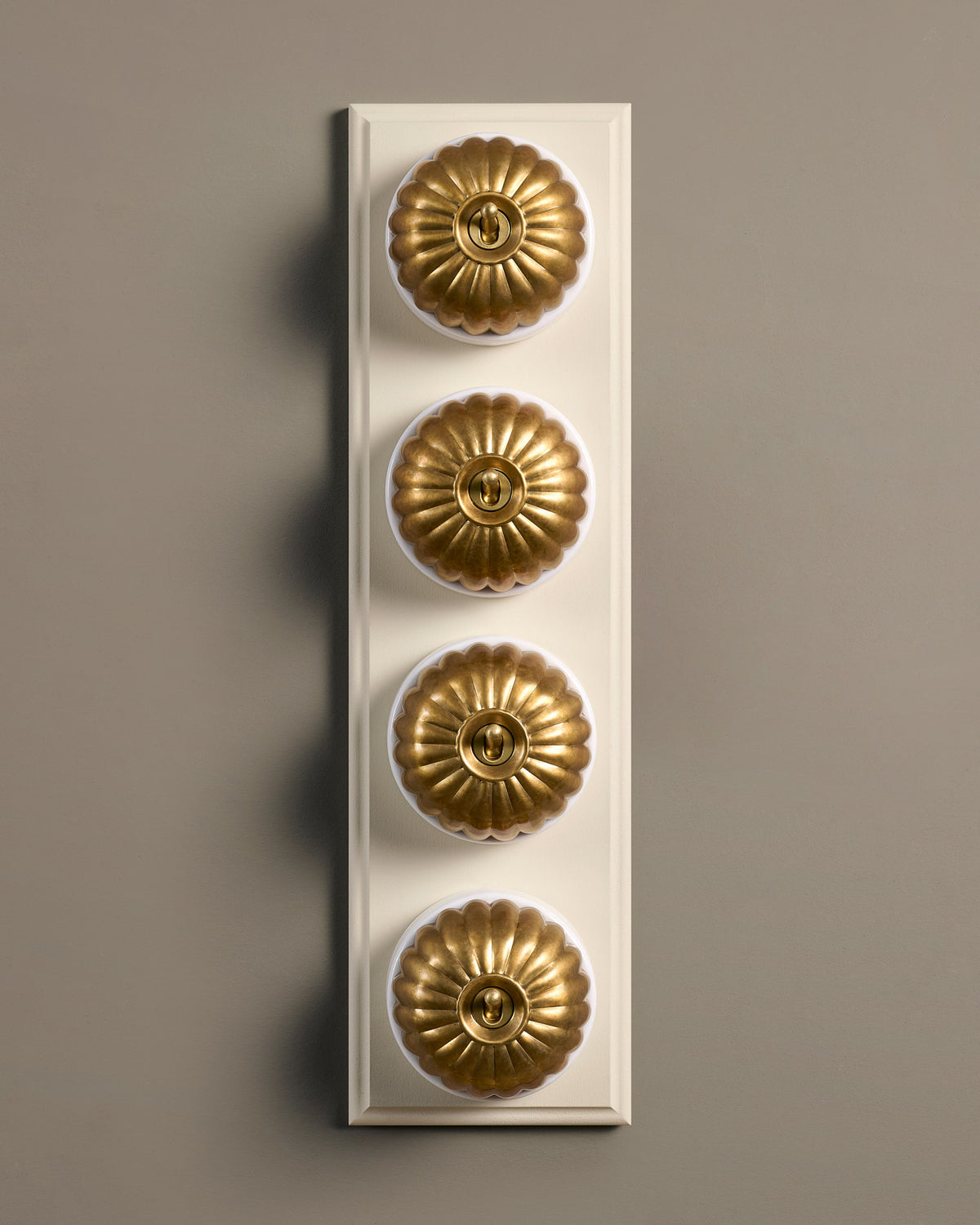 The Jelly Toggle Switch (4 Gang Row & Primed Maple Pattress) - Aged Brass with White Base. TEST