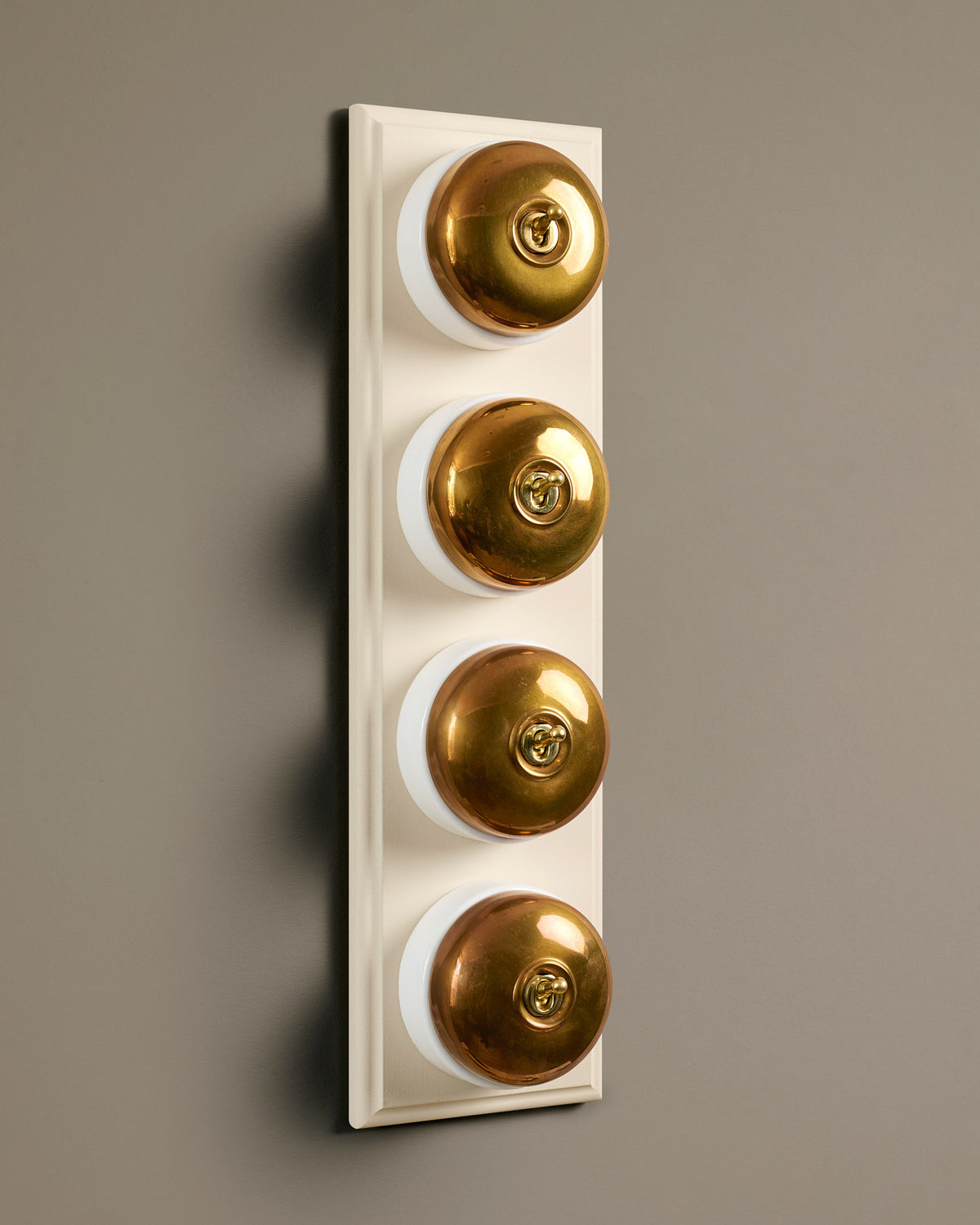 The Dolly Toggle Switch (4 Gang Row & Primed Maple Pattress) - Heirloom Brass with White Base. TEST