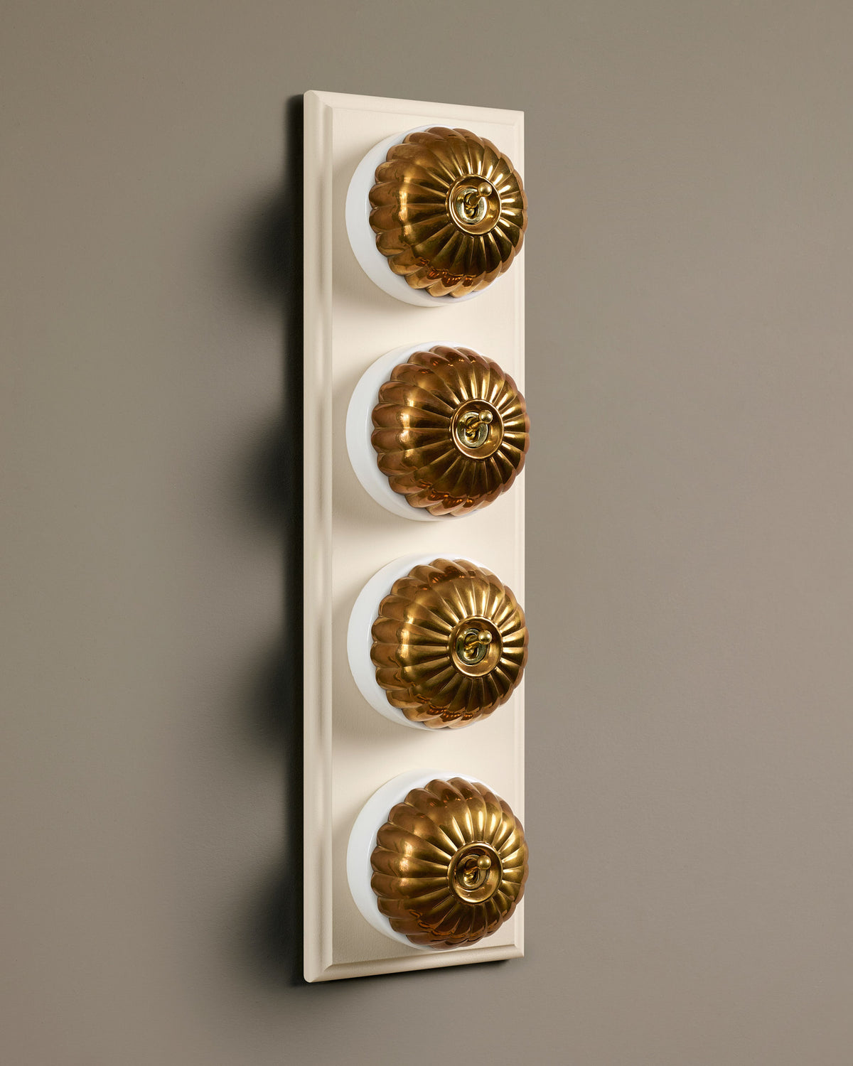The Jelly Toggle Switch (4 Gang Row & Primed Maple Pattress) - Heirloom Brass with White Base. TEST
