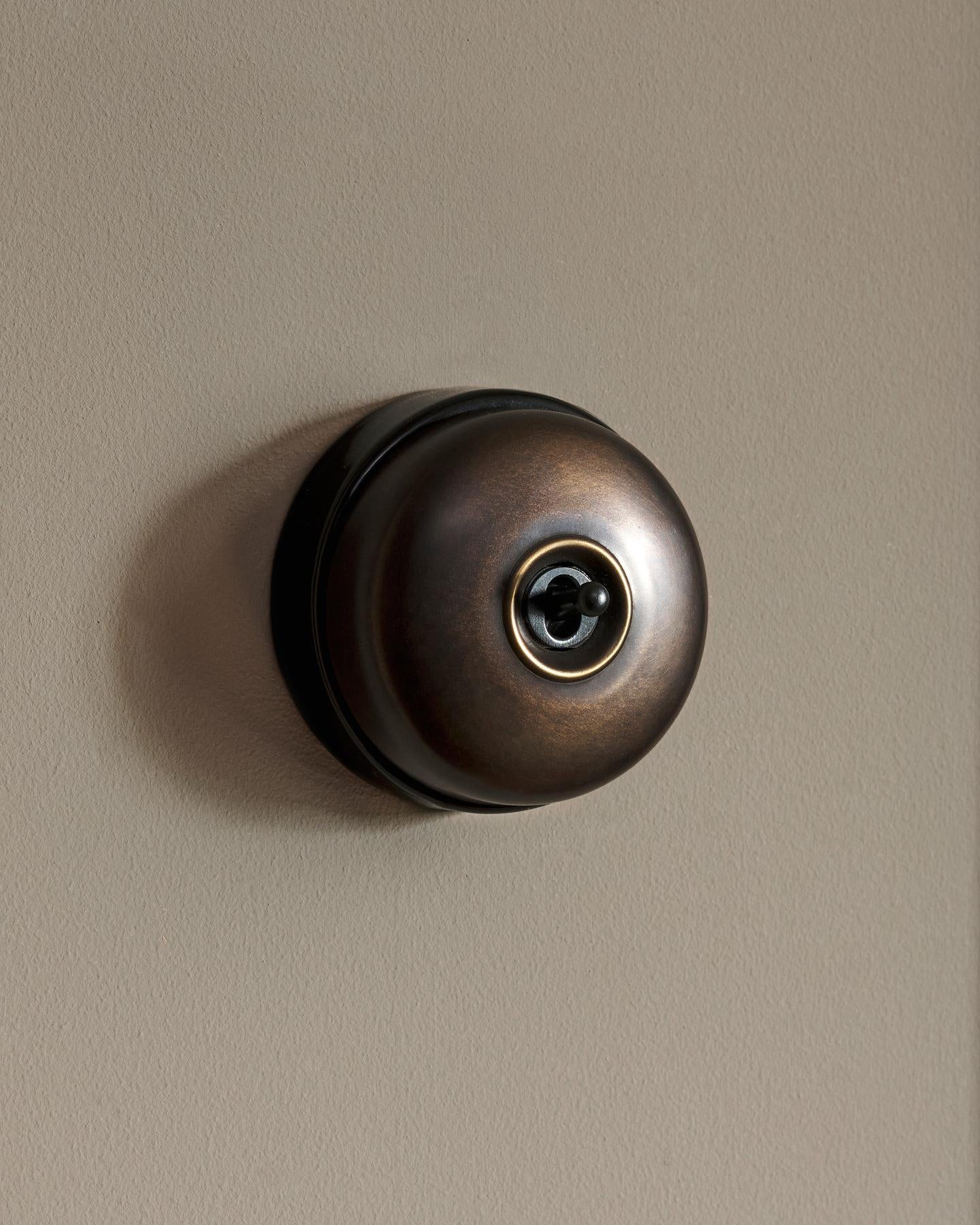 The Dolly Toggle Switch - Oxidised Brass, Black Base, Retract to Centre