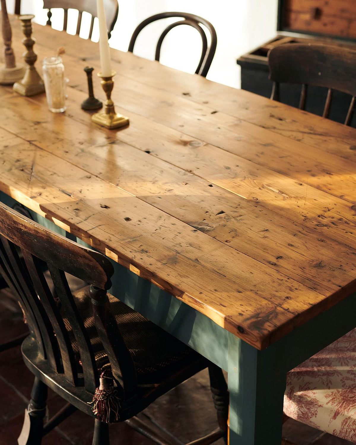 An oblique view of a rustic pine tabletop from a banquet-style dining table. TEST