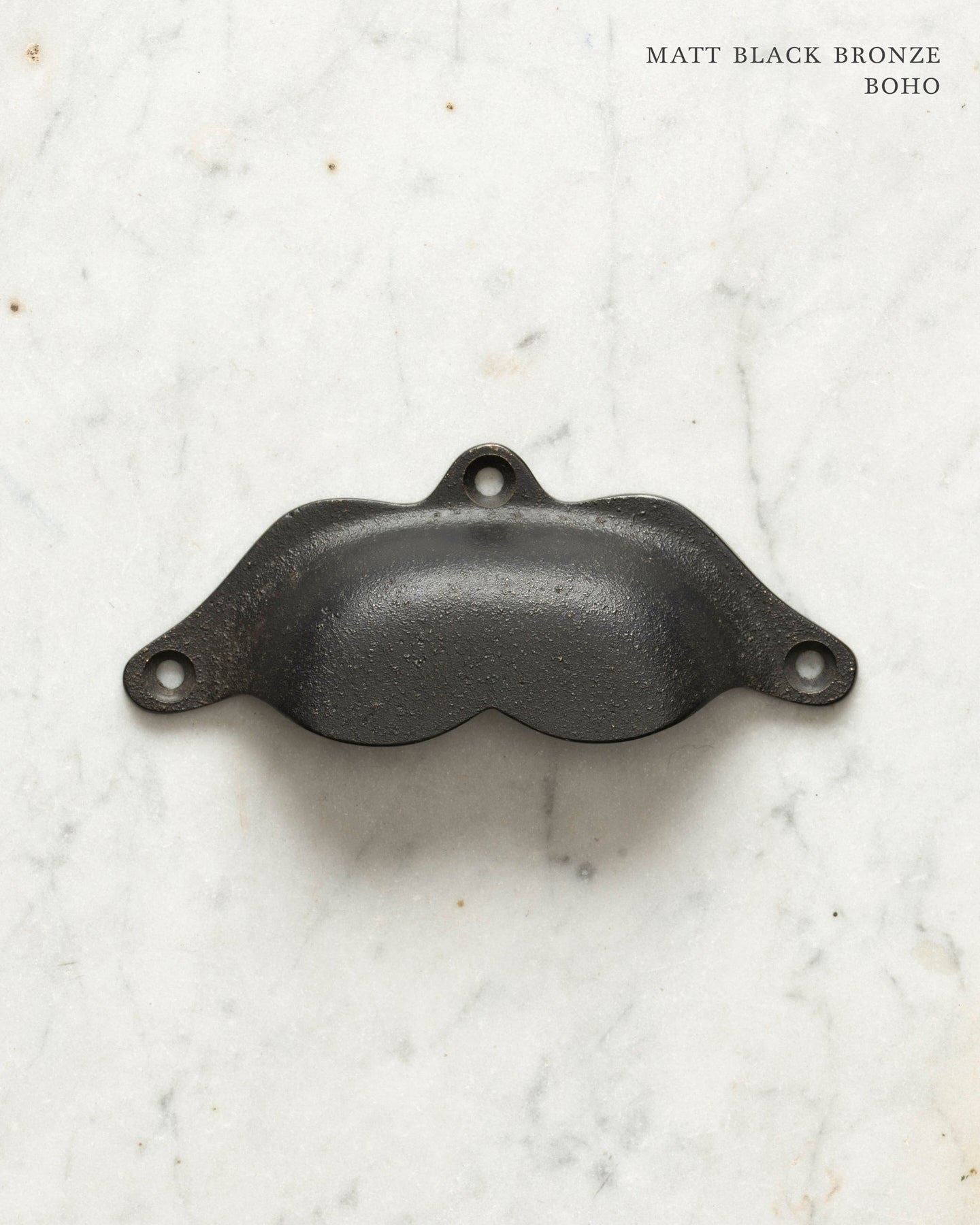 Two bohemian-style cup handles for a kitchen cupboard or drawer with a matt black bronze finish. There is a large and a small size.