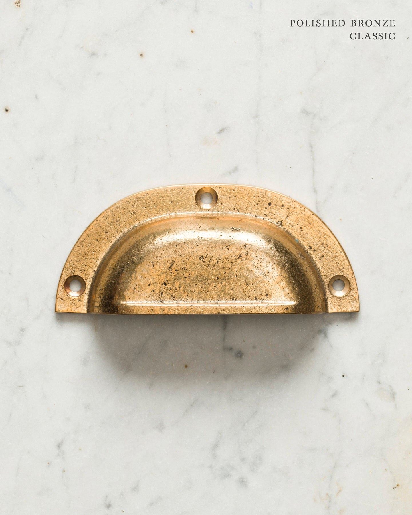 Two classic cup handles for a kitchen cupboard or drawer with a bright polished bronze finish. There is a large and a small size.