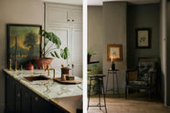 A printer’s black Shaker kitchen featuring a kitchen island with a San Simone quartzite worktop, a copper sink, and aged brass Mayan taps. Adorned with vintage furniture, artisan ceramics, lush flora and fauna, and antique memorabilia, it creates a classic, chic kitchen with a touch of personality.
