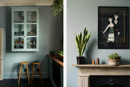 A sweet and simple Clerkenwell blue Sebastian Cox kitchen features a short cooker and sink run with a copper worktop and splashback, and a glazed wall cupboard. Adorned with artisan ceramics, vintage bric-a-brac, hanging plants, a framed quirky illustration, and Helen stools, this kitchen creates a glamorous and practical space.