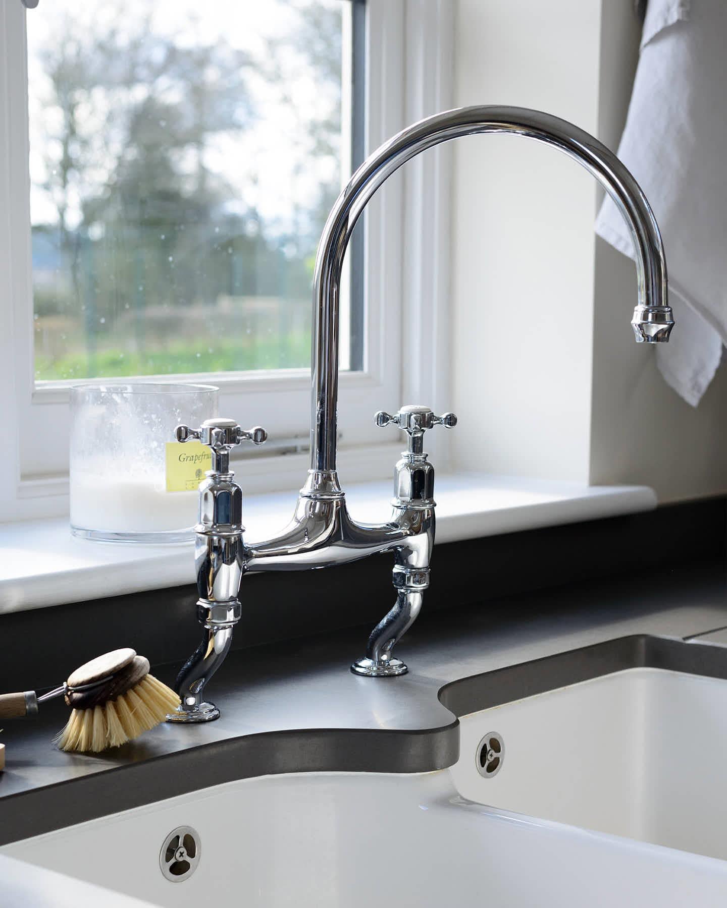 A close-up oblique view of a traditional-style chrome mixer tap with crosshead handles.