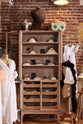 A closer look at the glazed freestanding pantry cupboard from the deVOL Haberdasher’s collection reveals a kitchen island and countertop cupboards. Adorned with deVOL Heirloom accessories, creamware pendant lights, porcelain pendant lights, Helen stools, vintage furniture and items, dressmaker mannequins, and 1900s tailor tools, this space creates a beautiful homage to the English gentlemen’s haberdashery inspiration in a bricked wall showroom.