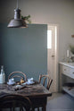 A closer look at the vintage square dining table with chairs and the small rolling kitchen island with Carrara marble worktop to serve humble meals.