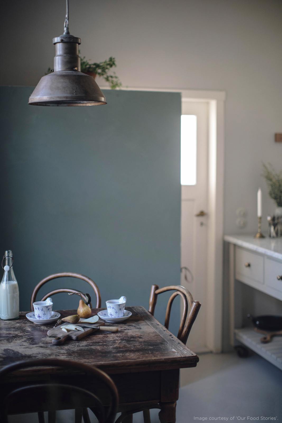 A closer look at the vintage square dining table with chairs and the small rolling kitchen island with Carrara marble worktop to serve humble meals.