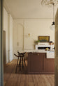 A bright, spacious, warm, and simple-yet-grand shaker kitchen featuring a large kitchen island with a Calacatta Viola worktop. Perfectly decorated with beloved vintage furniture and decor made from different natural materials, it creates a scene of absolute beauty, personality and functionality.