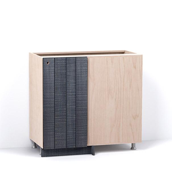 A render of a blind corner cabinet from deVOL's Sebastian Cox range, with a single door made from individual planks and finished with an inky-blue stain and band-sawn texture.