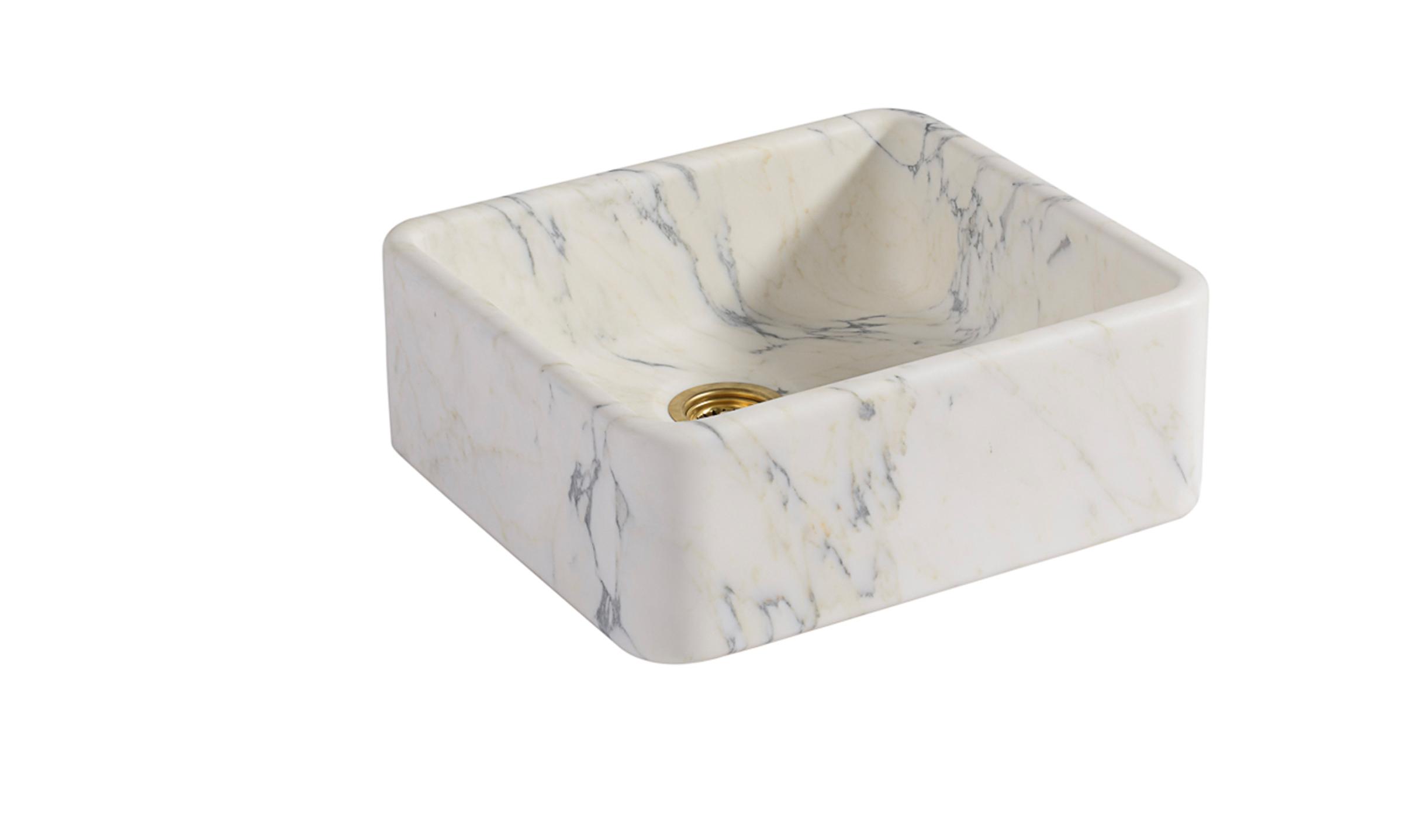 A cut-out image of a honed marble sink with a combination of dramatic bluey-grey and pale cream veining.