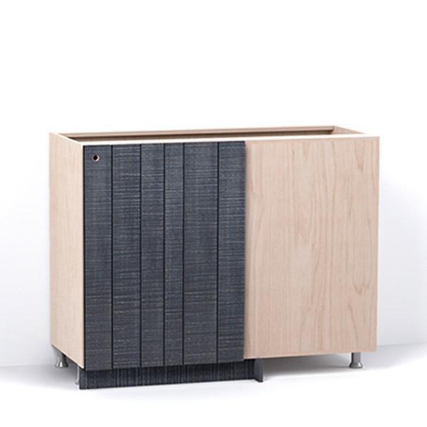 A render of a blind corner cabinet from deVOL's Sebastian Cox range, with a single door made from individual planks and finished with an inky-blue stain and band-sawn texture.