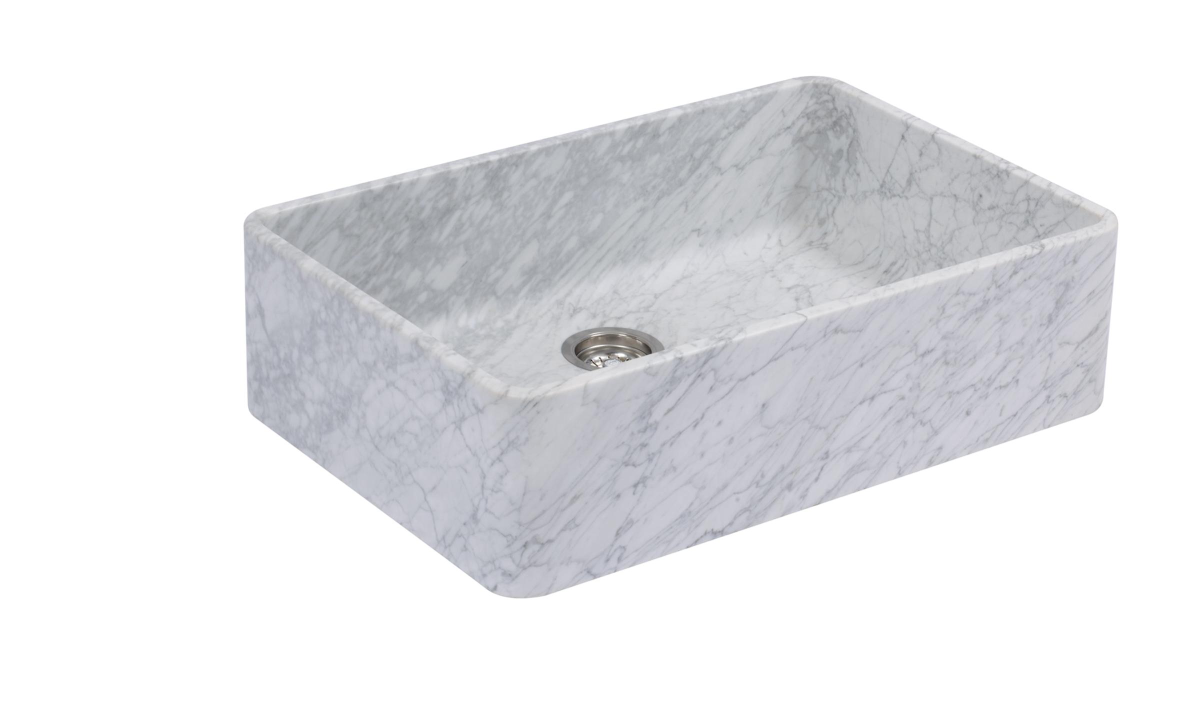 A cut-out image of a honed marble sink with soft and subtle grey veining.