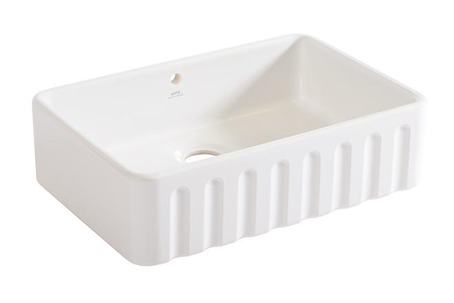 A cut-out image of a traditional fluted white ceramic Belfast sink.