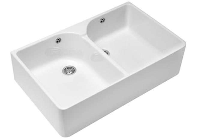 A cut-out image of a traditional white ceramic Belfast sink with two basins.