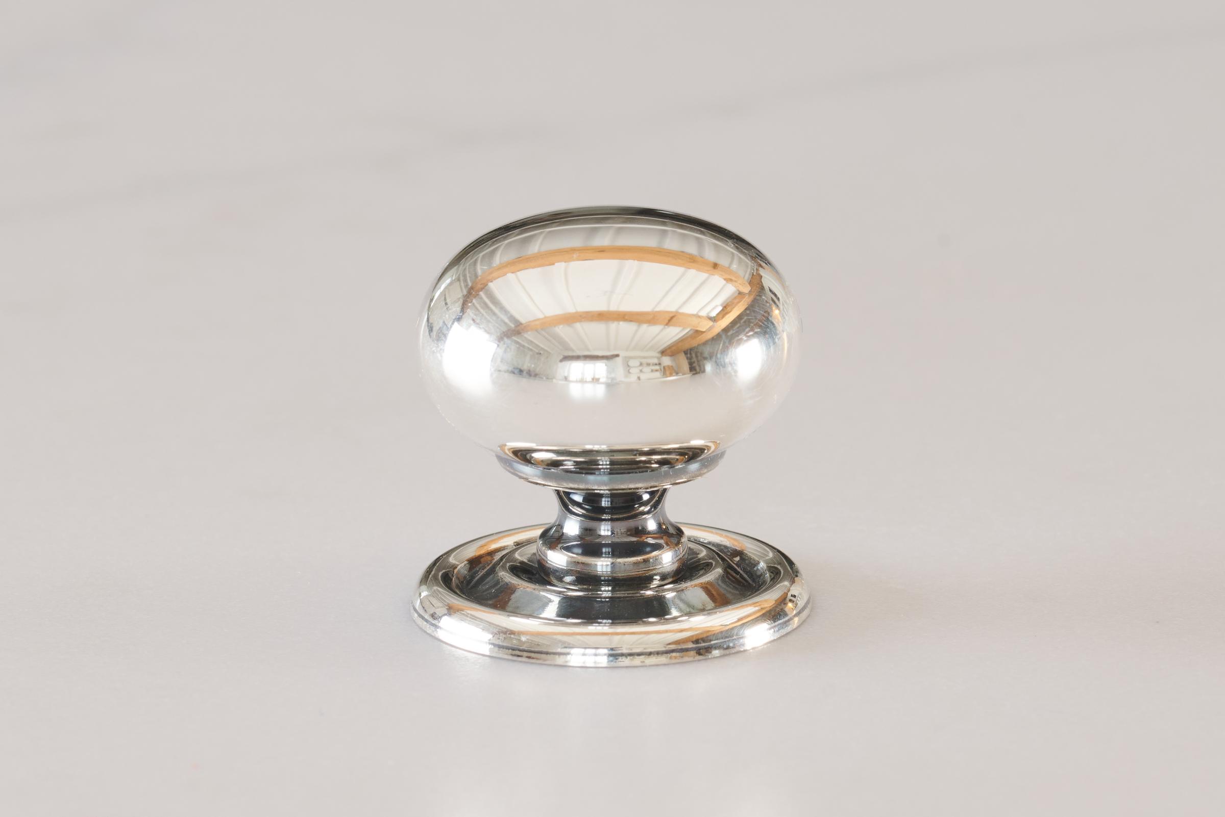 A ‘Medium’ round doorknob with a pressed backplate for a kitchen cupboard or drawer in a tarnished silver finish.