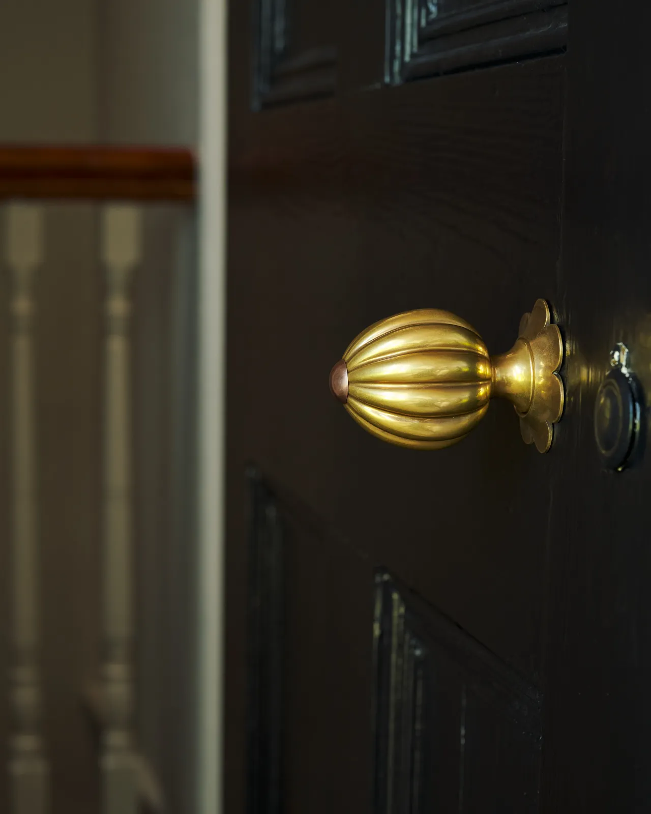 Marguerite Doorknob on a black door.