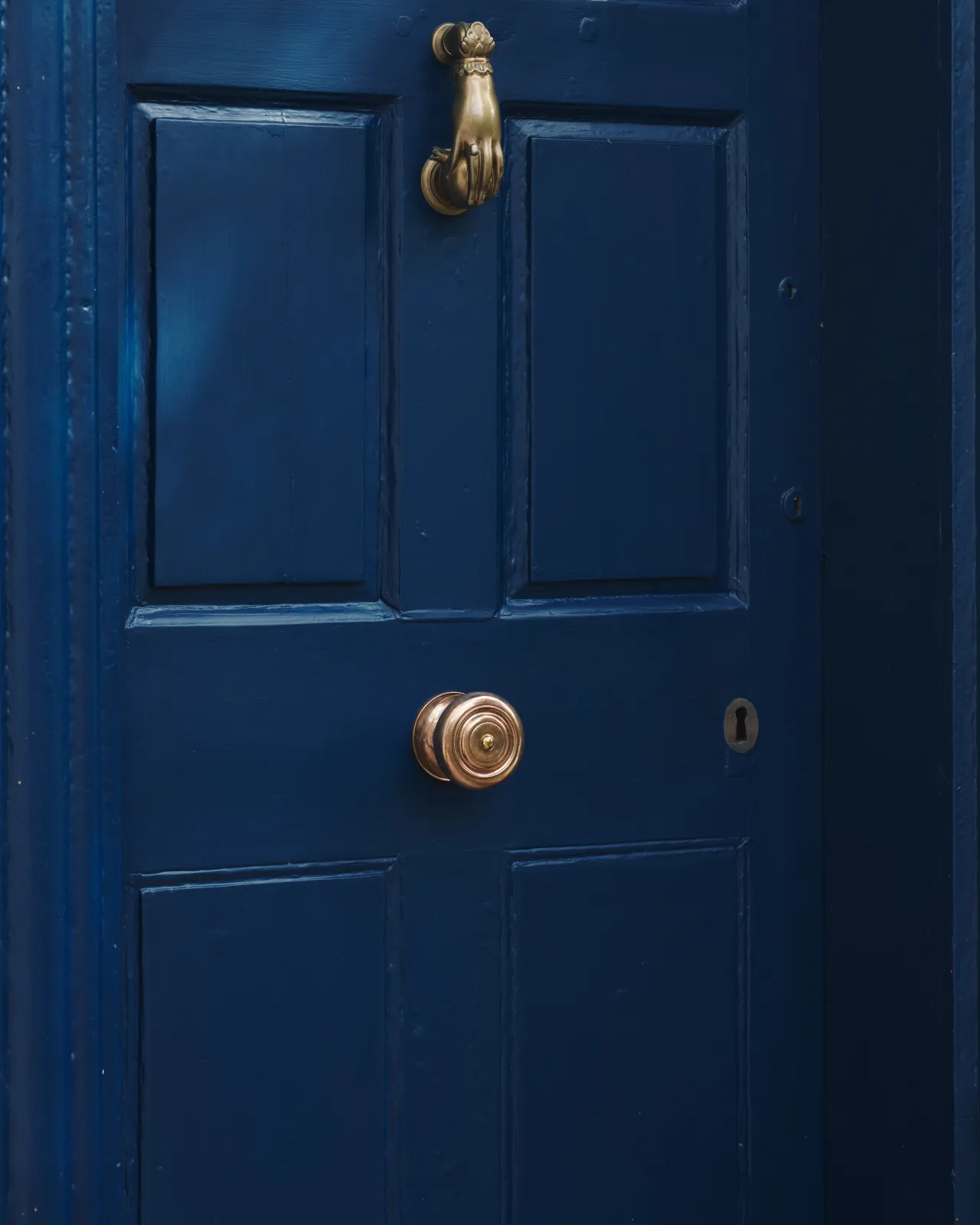 the grand romilly centrepull on a blue wooden door.