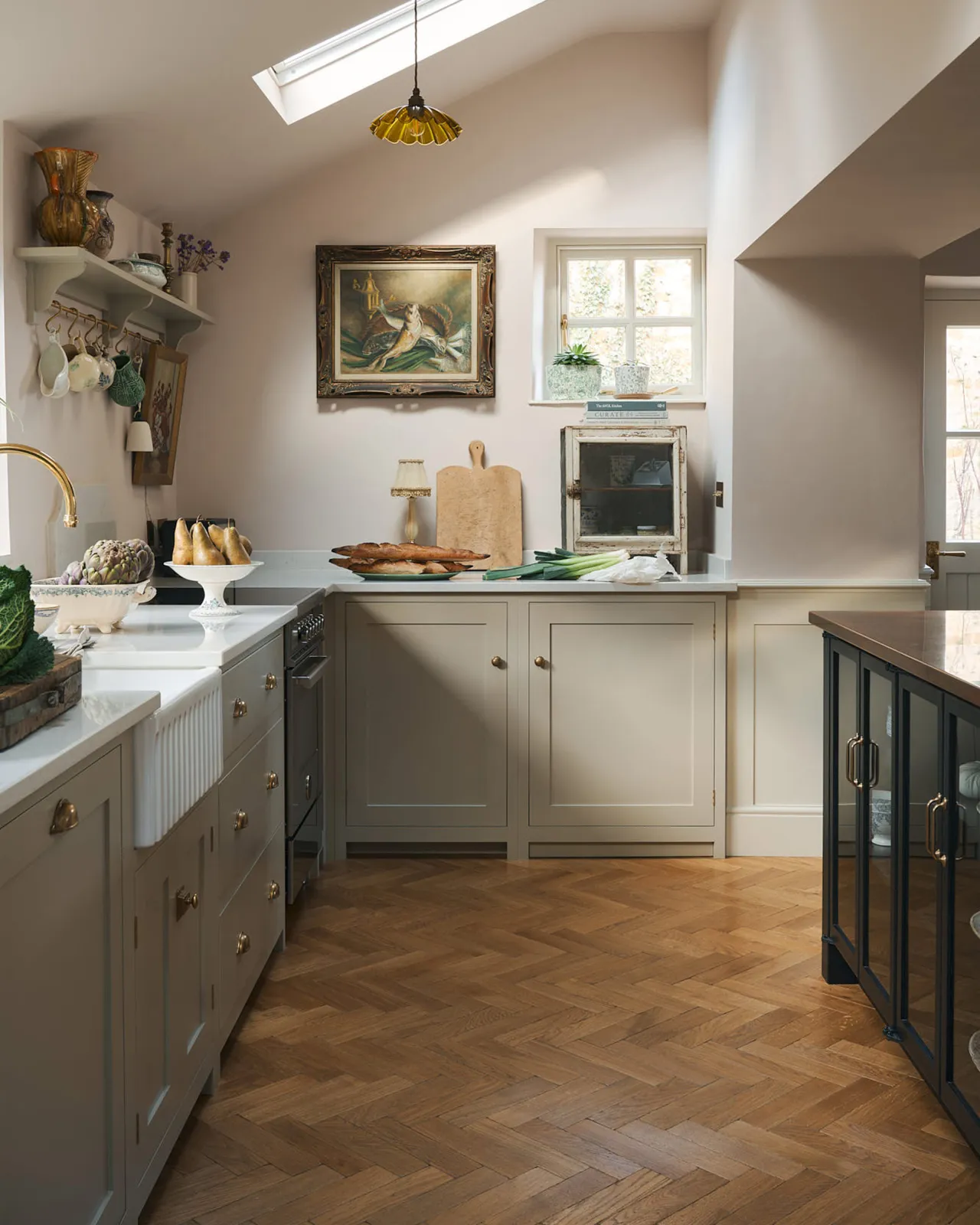 A beautiful mushroom deVOL Shaker kitchen with a warm wooden Chatsworth Parquet floor.