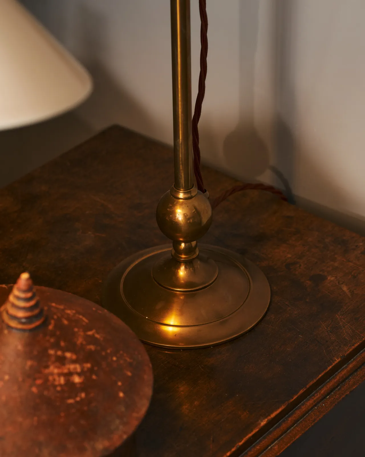 A close up of The Grand Tour Desk Lamp brass base.