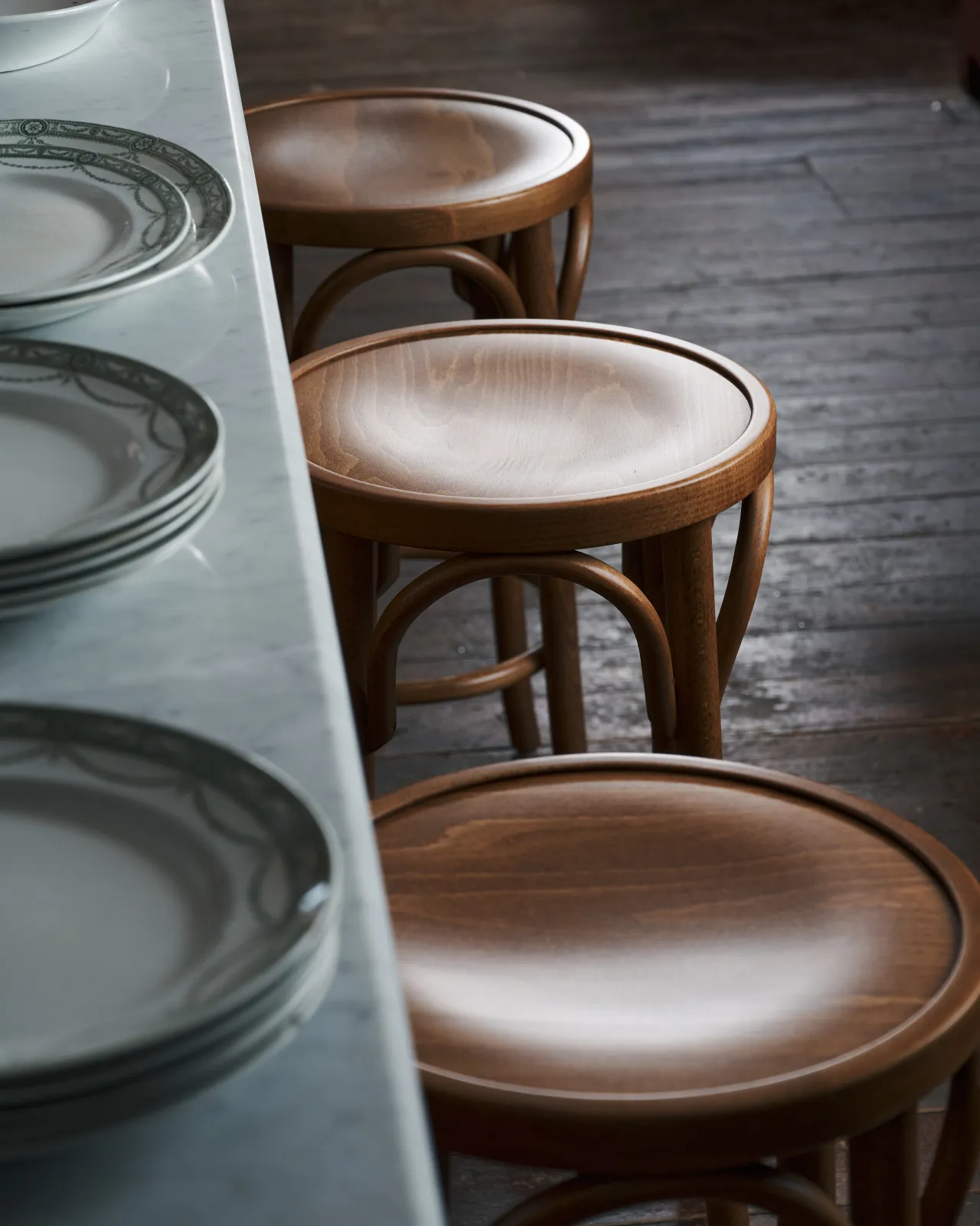 a side shot of three cafe stool next to the dairy table.