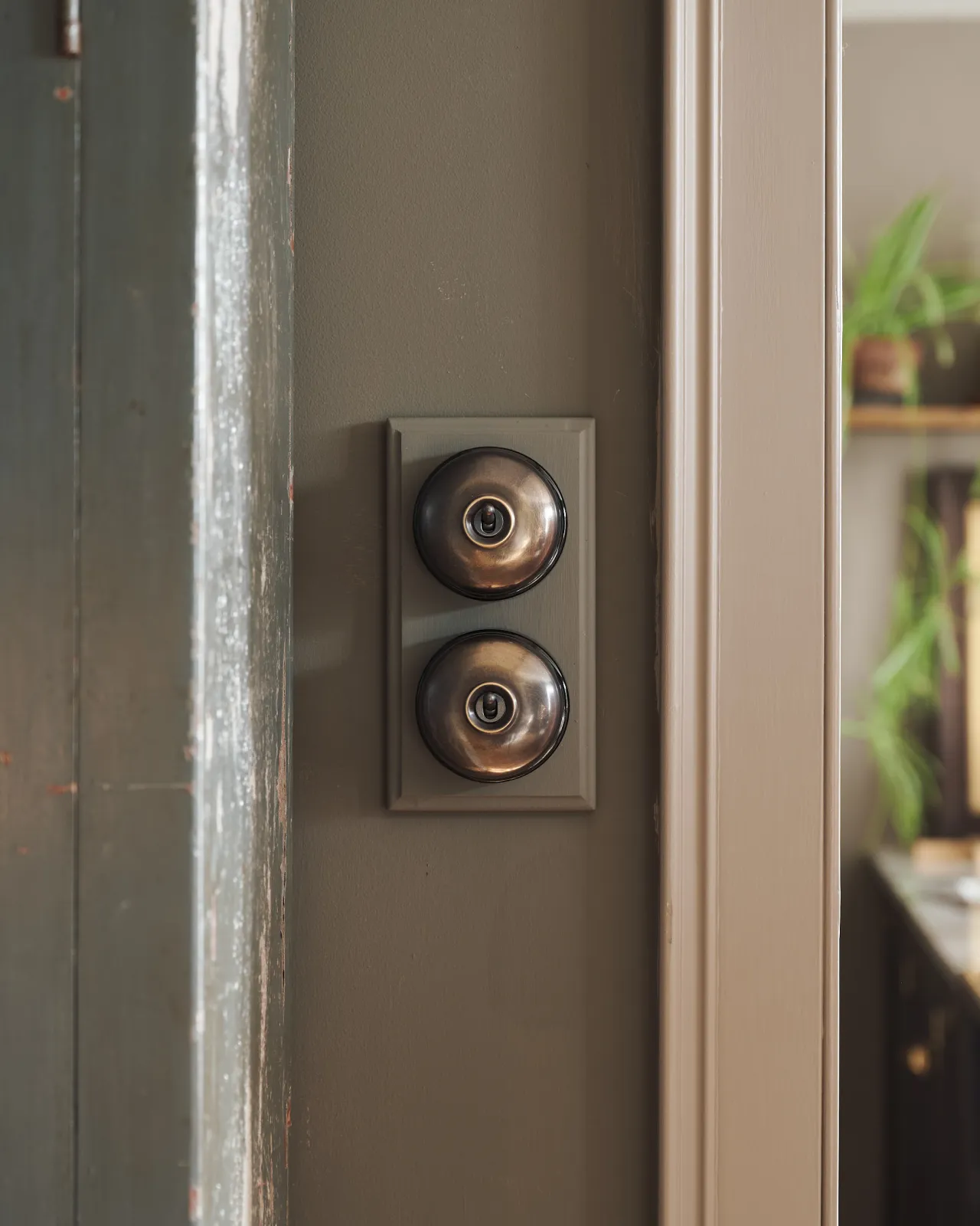 A pair of deVOL Dolly Toggle Switches fitted to a painted pattress.