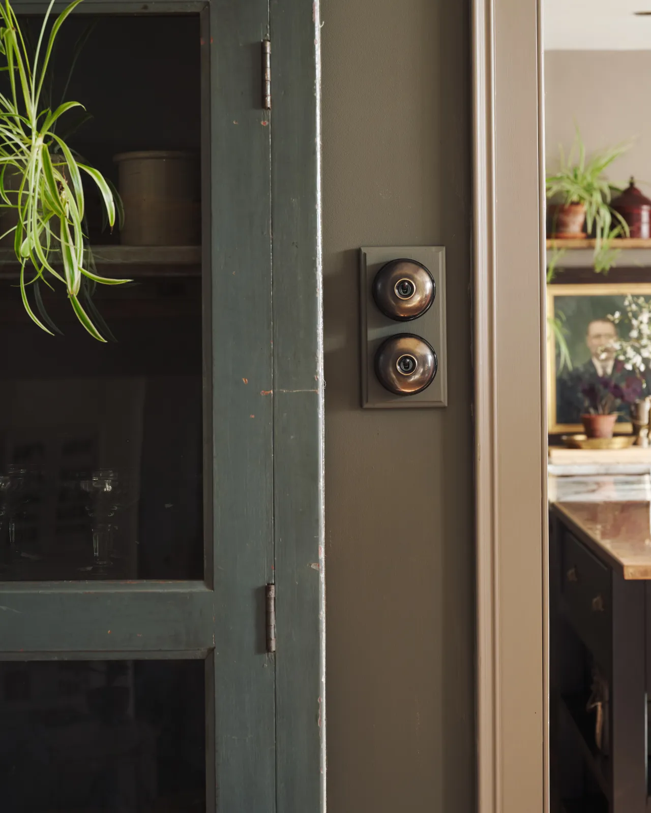 A pair of deVOL Dolly Toggle Switches fitted to a painted pattress.